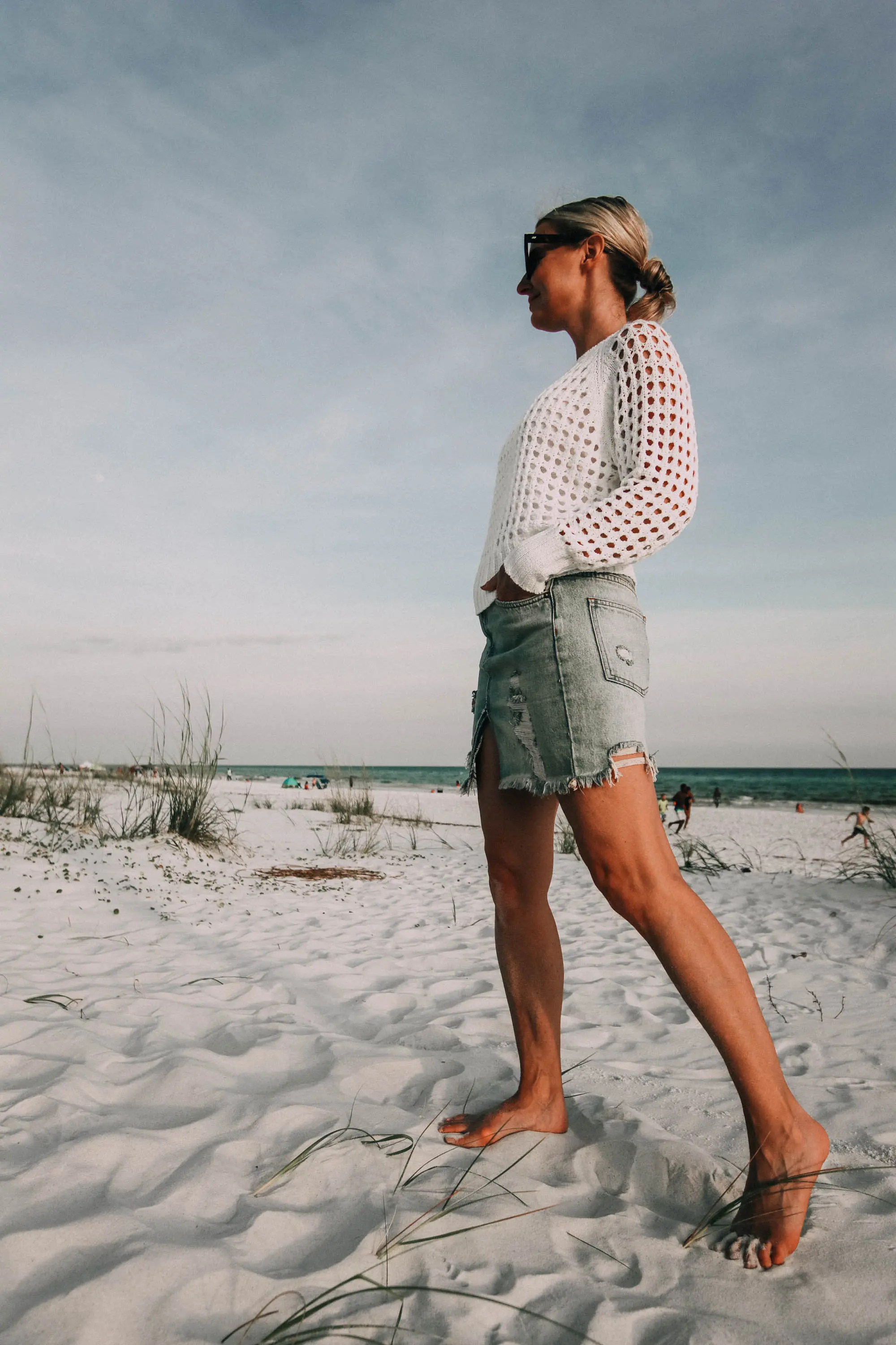 Denim Skirts, Fashion blogger Erin Busbee of BusbeeStyle.com wearing a denim skirt by Free People with a white knit sweater from Nordstrom on the beach in Florida
