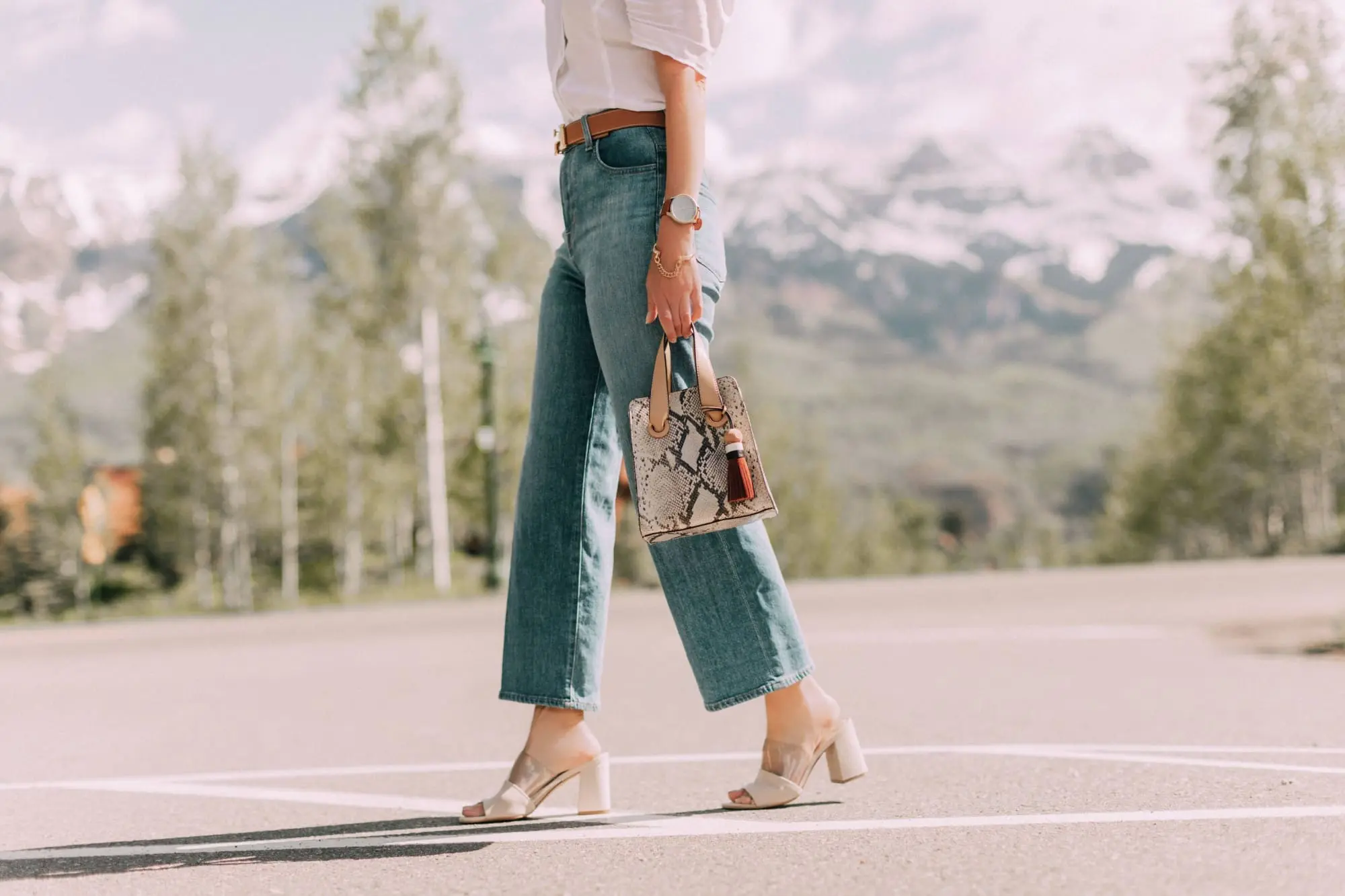 Lucite Trend, Fashion blogger Erin Busbee of BusbeeStyle.com wearing lucite mules from Vince Camuto with J Brand jeans, white Leith top, Hermes belt, and a python print Vince Camuto bag in Telluride, Colorado