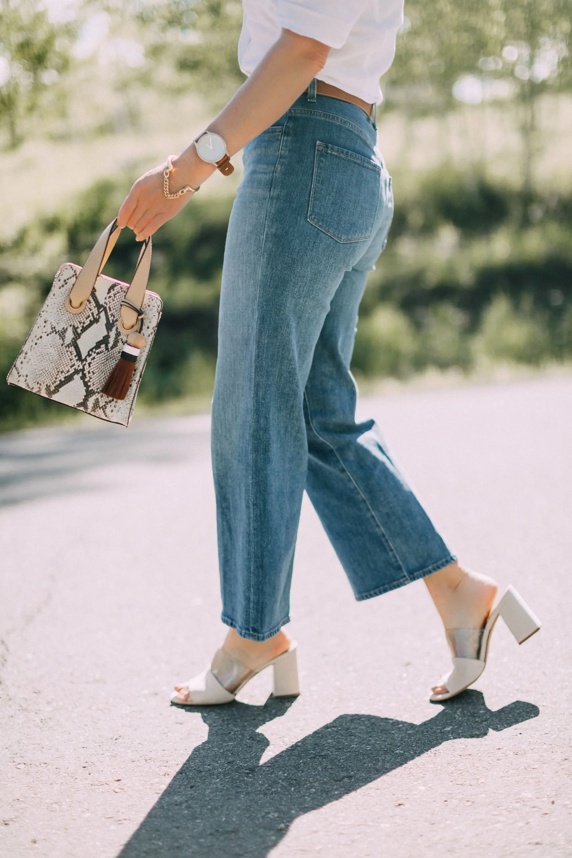 Lucite Trend, Fashion blogger Erin Busbee of BusbeeStyle.com wearing lucite mules from Vince Camuto with J Brand jeans, white Leith top, Hermes belt, and a python print Vince Camuto bag in Telluride, Colorado