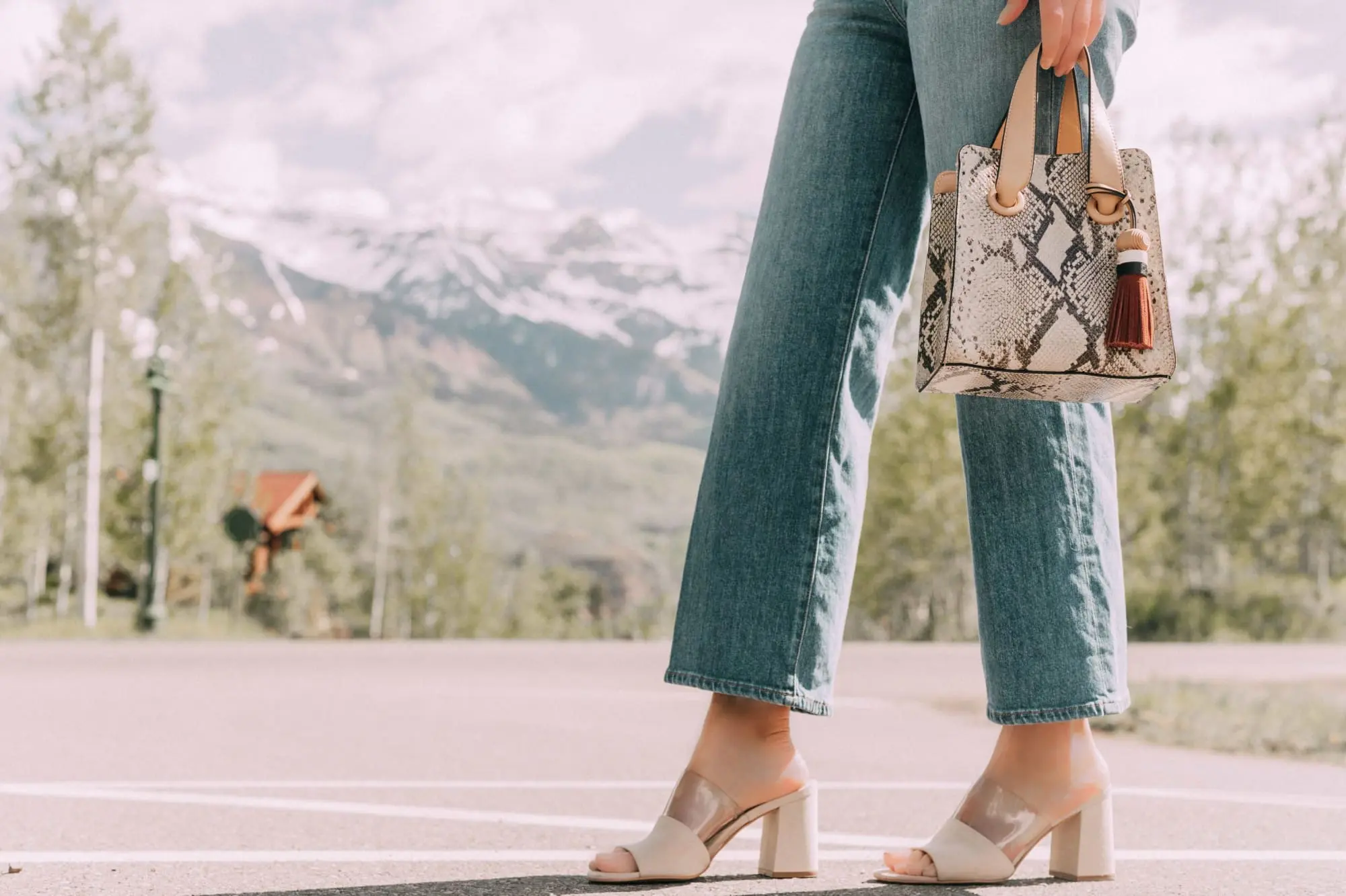 Lucite Trend, Fashion blogger Erin Busbee of BusbeeStyle.com wearing lucite mules from Vince Camuto with J Brand jeans, white Leith top, Hermes belt, and a python print Vince Camuto bag in Telluride, Colorado