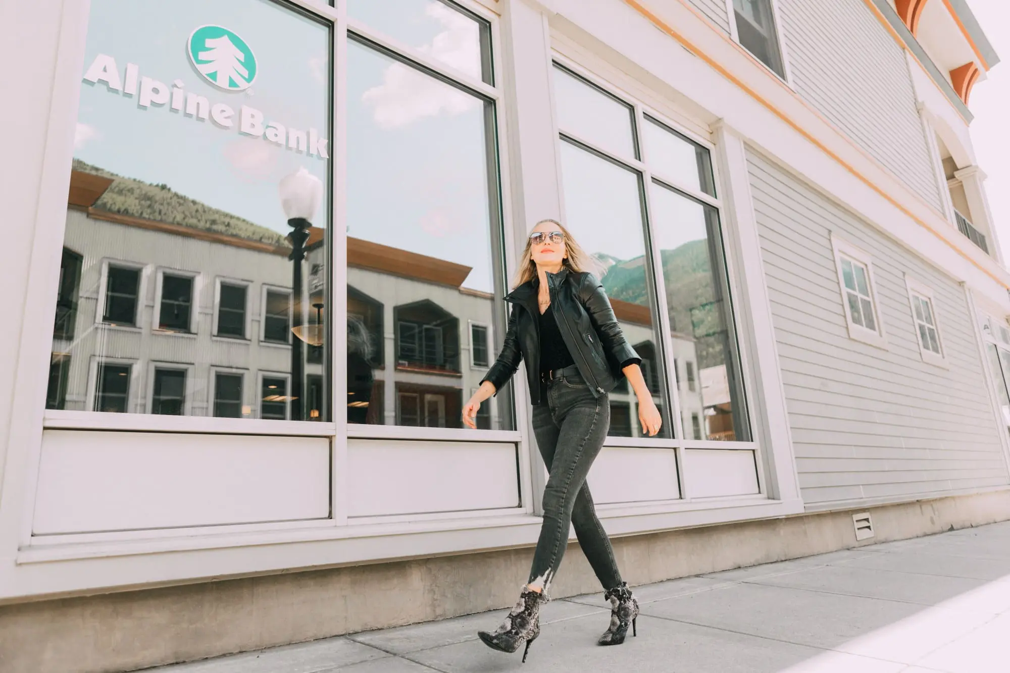Leather Moto Jacket, Fashion blogger over 40 Erin Busbee of BusbeeStyle.com featuring the Chelsea28 black leather jacket from the Nordstrom Anniversary Sale 2019 styled with the velvet leopard bodysuit, Topshop jeans, and Charles Davidson python print booties from Nordstrom in Telluride, Colorado