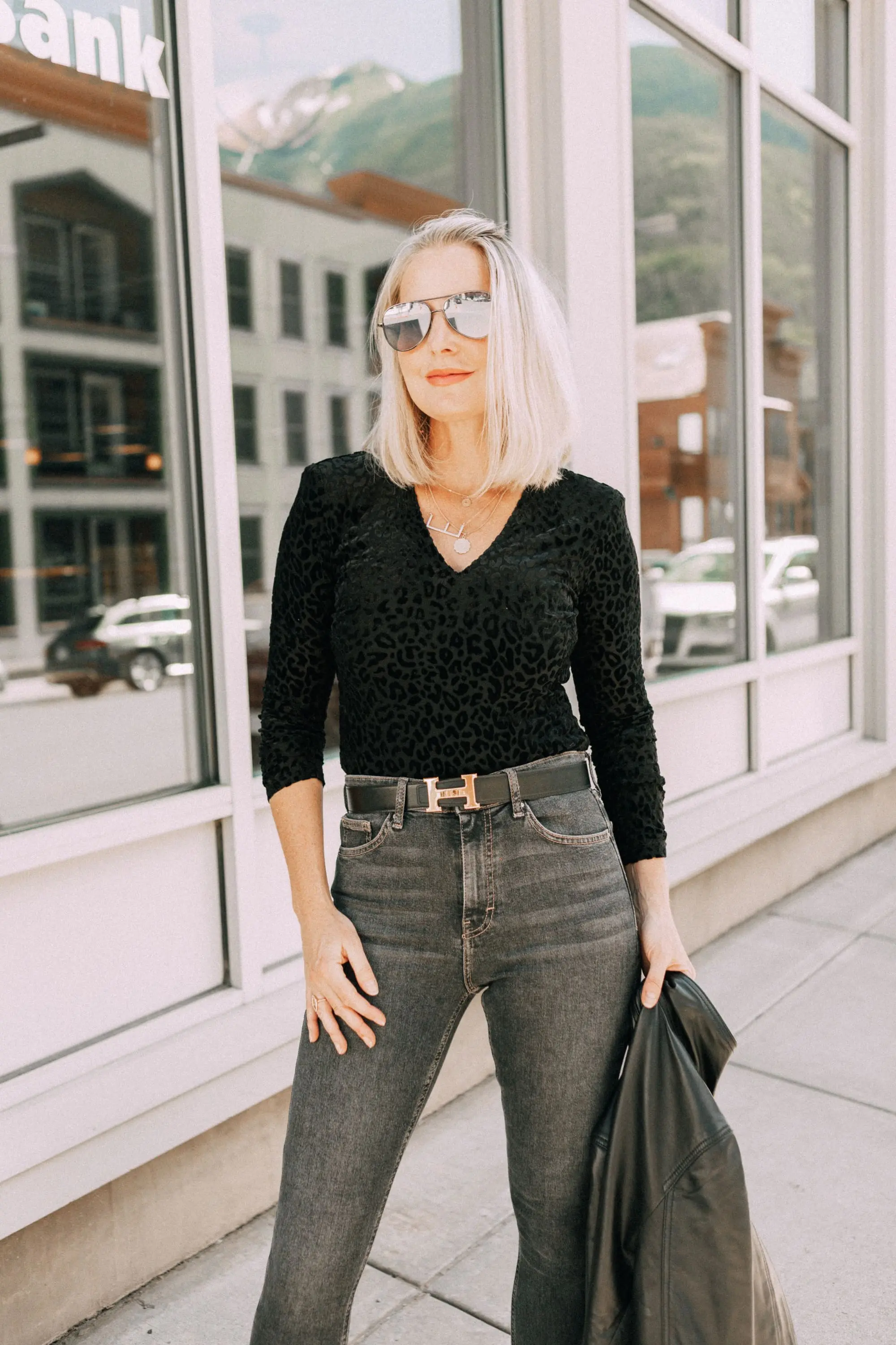 Leather Moto Jacket, Fashion blogger over 40 Erin Busbee of BusbeeStyle.com featuring the Chelsea28 black leather jacket from the Nordstrom Anniversary Sale 2019 styled with the velvet leopard bodysuit, Topshop jeans, and Charles Davidson python print booties from Nordstrom in Telluride, Colorado
