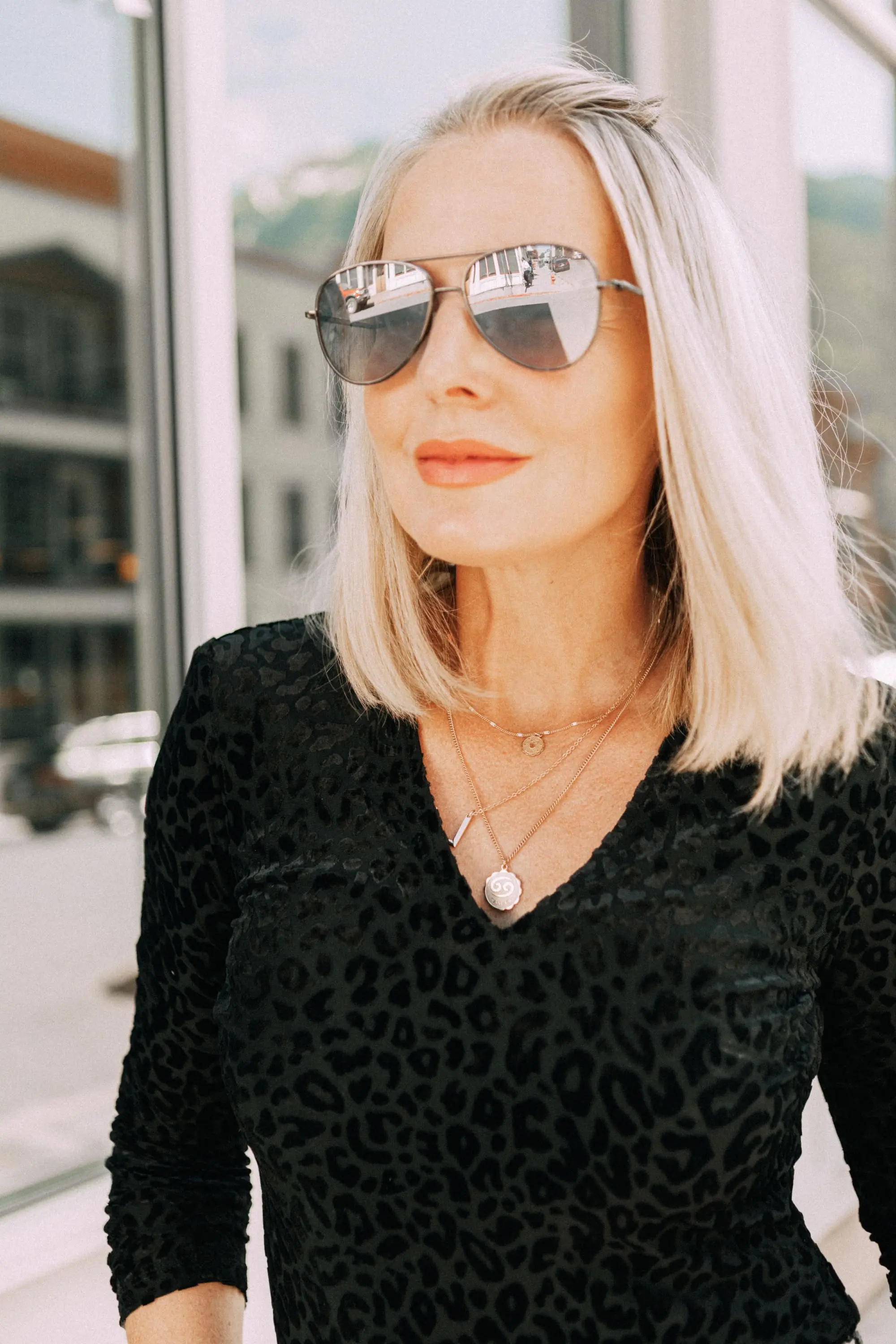 Leather Moto Jacket, Fashion blogger over 40 Erin Busbee of BusbeeStyle.com featuring the Chelsea28 black leather jacket from the Nordstrom Anniversary Sale 2019 styled with the velvet leopard bodysuit, Topshop jeans, and Charles Davidson python print booties from Nordstrom in Telluride, Colorado