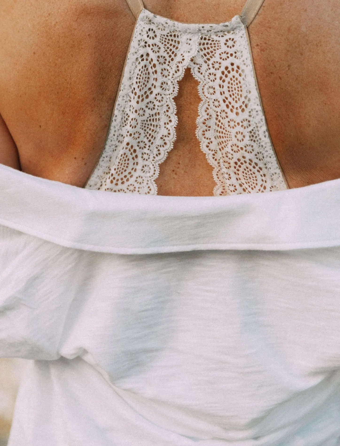 Racerback Bra, Fashion blogger Erin Busbee of BusbeeStyle.com wearing a racerback bra under a white button up tunic from Soma in Telluride, CO