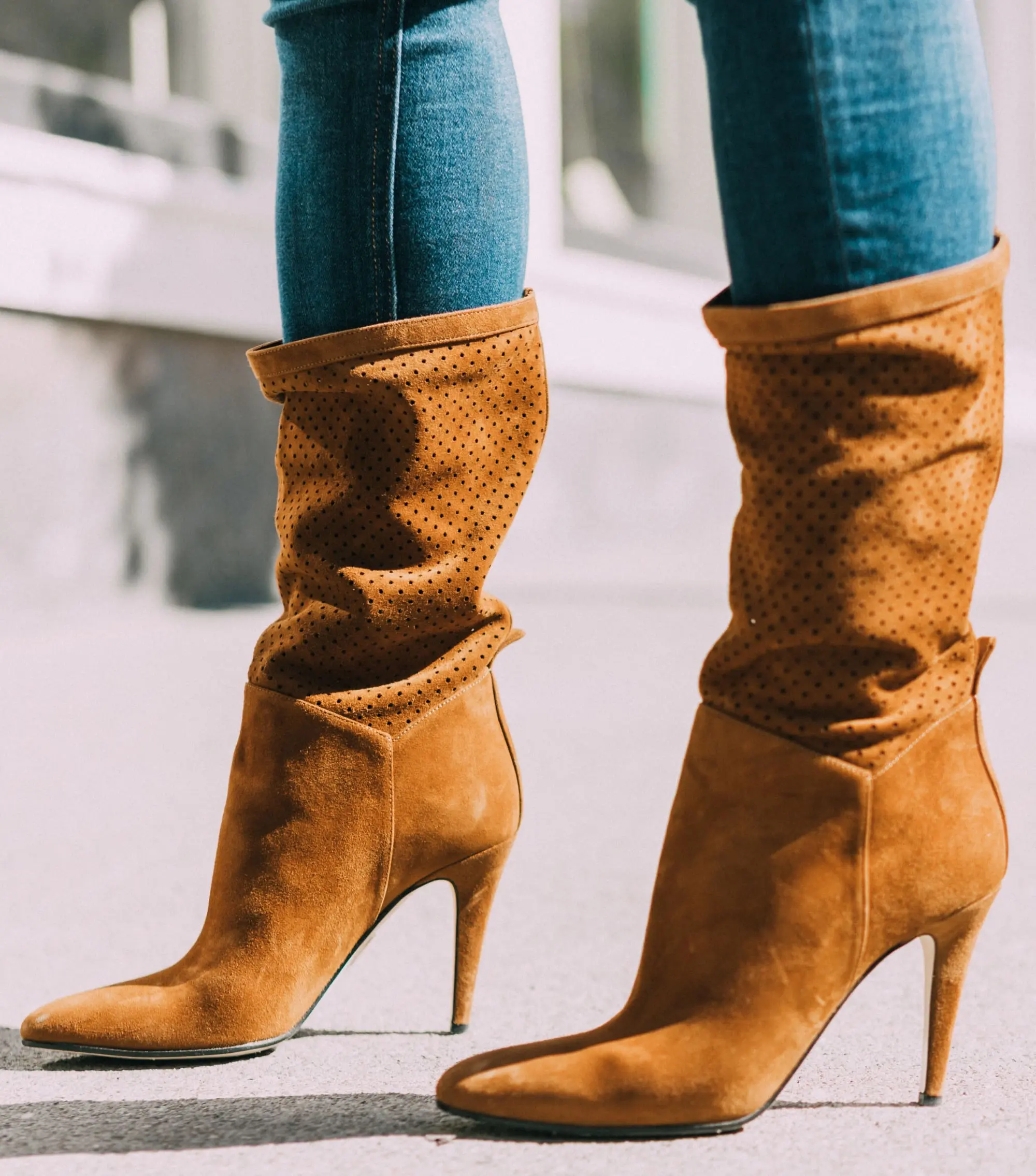 Tamara Mellon, Fashion blogger Erin Busbee of BusbeeStyle.com wearing dark was skinny jeans and white tee with stunning Tamara Mellon perforated brown boots in Telluride, Colorado