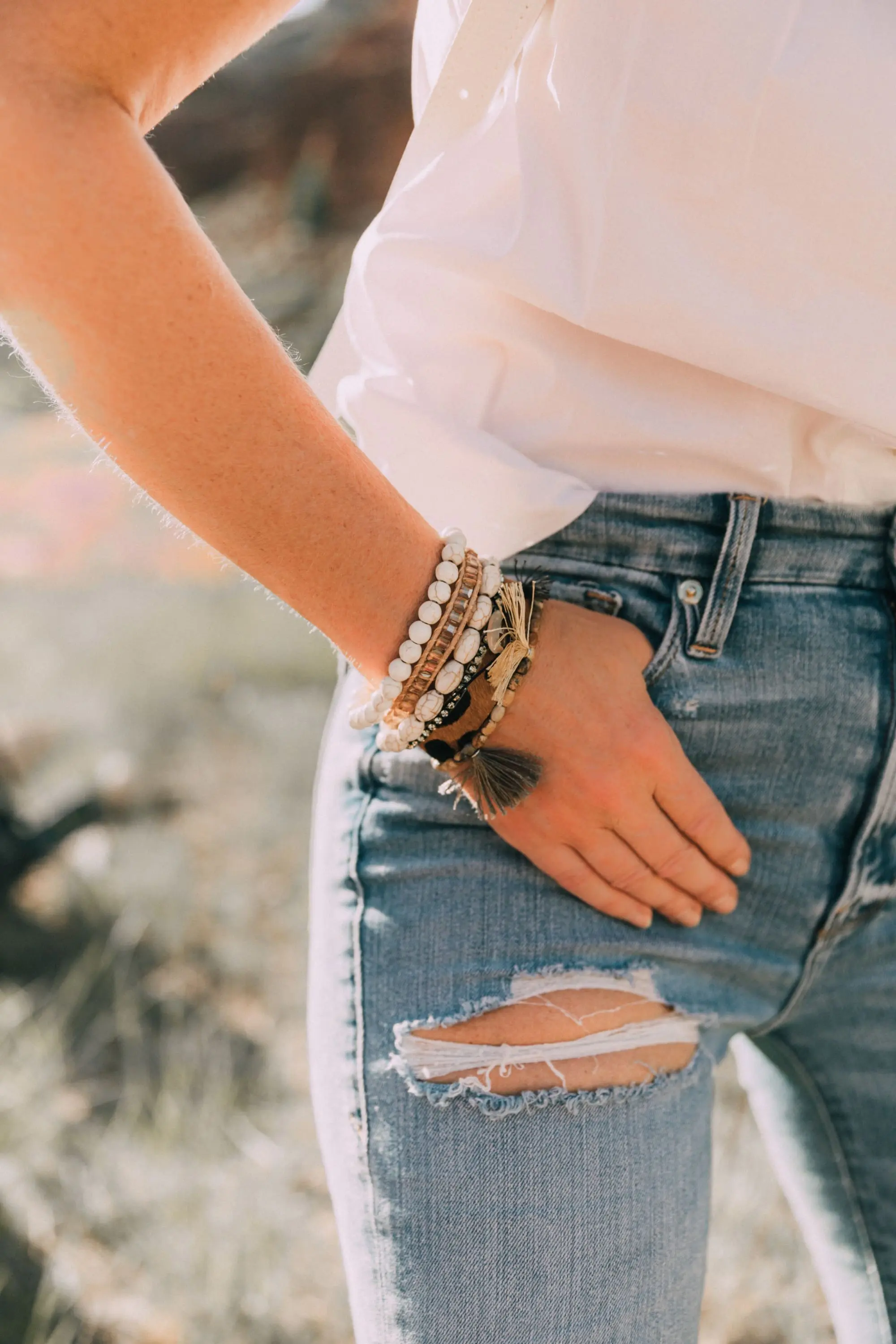 Victoria Emerson, Fashion blogger Erin Busbee of BusbeeStyle.com wearing a marble face watch, pearl wrap bracelet, brown leather wrap bracelet, and Cairo cuff from Victoria Emerson in Telluride, CO