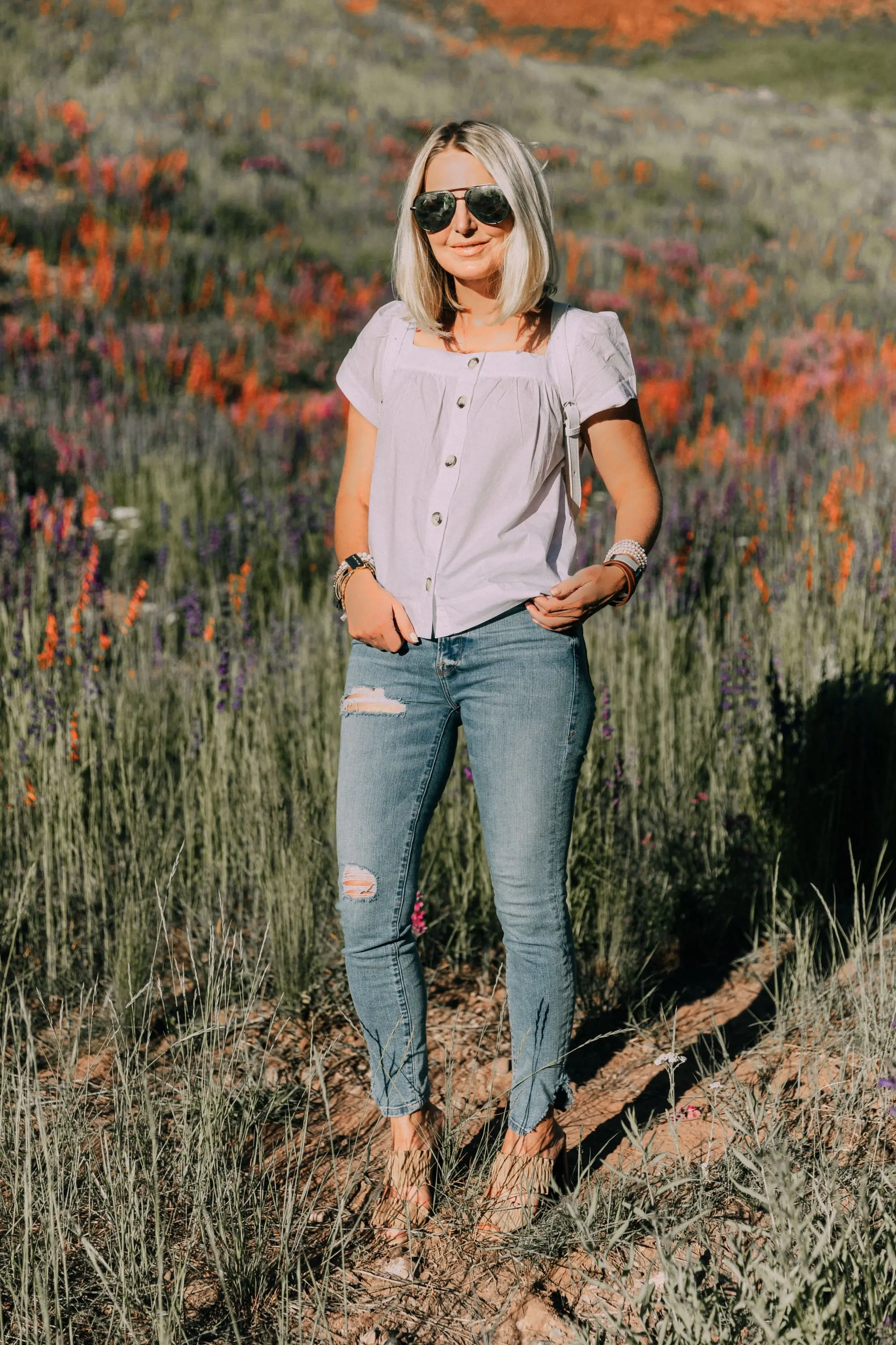 Victoria Emerson, Fashion blogger Erin Busbee of BusbeeStyle.com wearing a marble face watch, pearl wrap bracelet, brown leather wrap bracelet, and Cairo cuff from Victoria Emerson in Telluride, CO