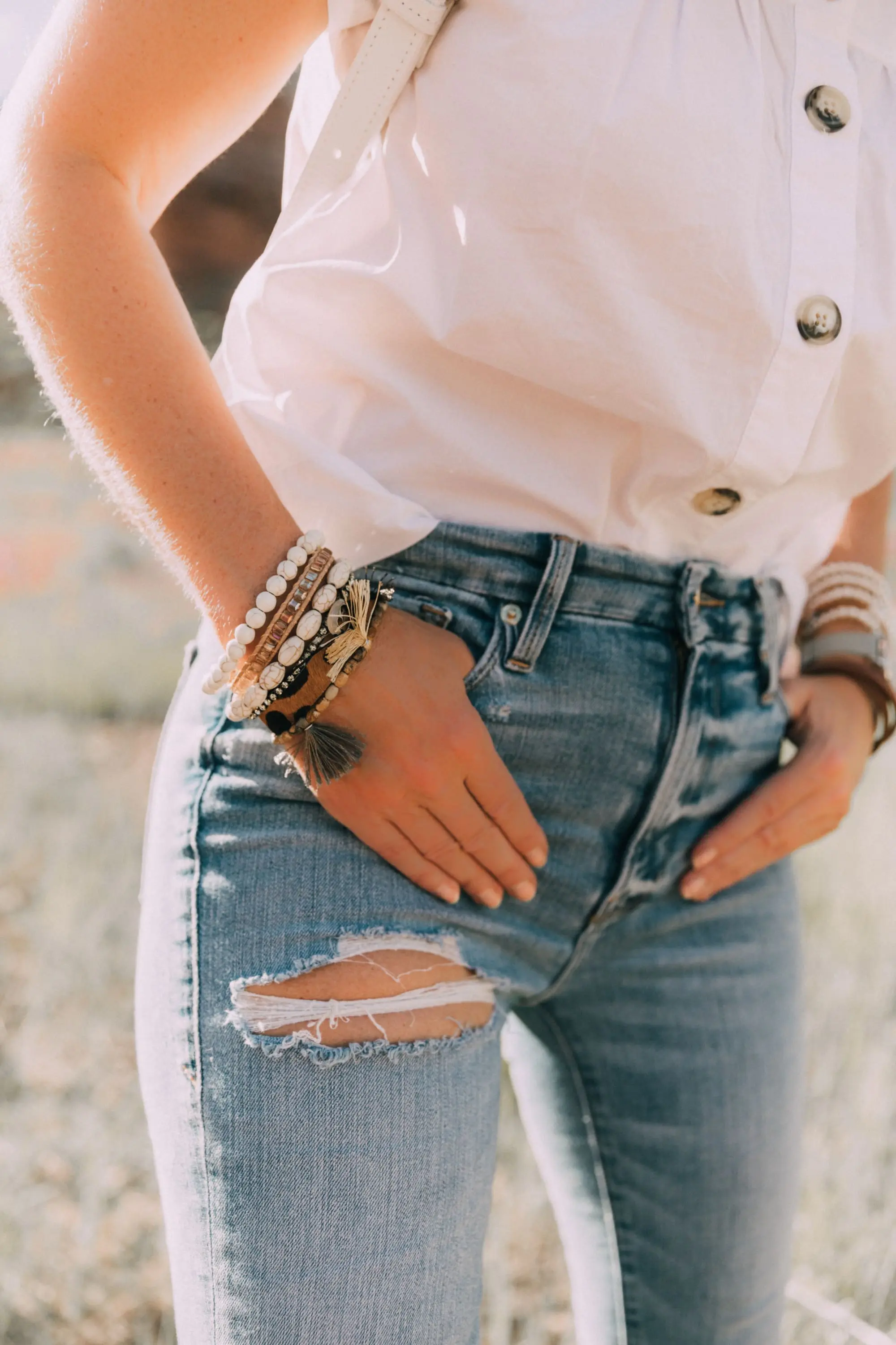 Victoria Emerson, Fashion blogger Erin Busbee of BusbeeStyle.com wearing a marble face watch, pearl wrap bracelet, brown leather wrap bracelet, and Cairo cuff from Victoria Emerson in Telluride, CO
