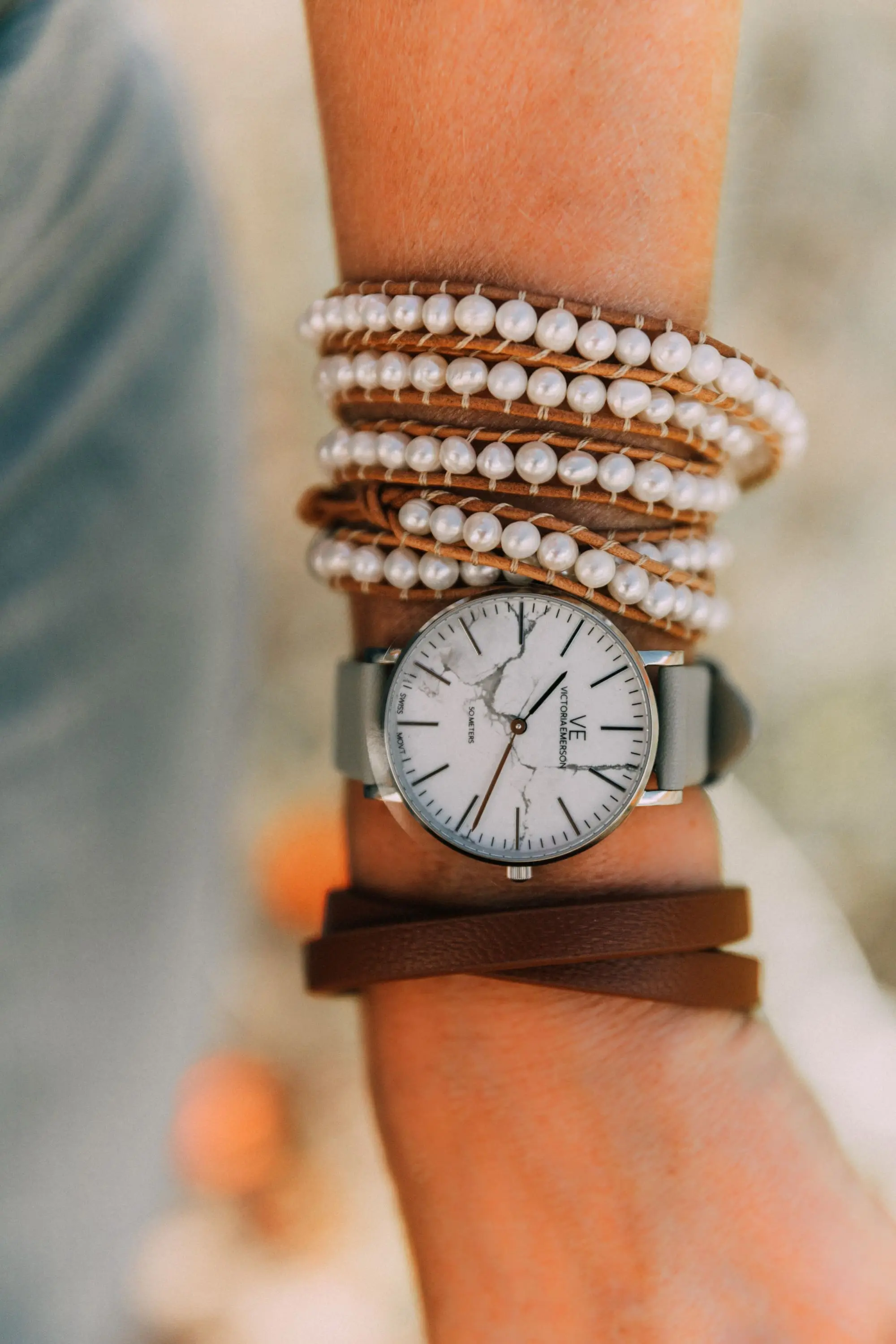 Victoria Emerson, Fashion blogger Erin Busbee of BusbeeStyle.com wearing a marble face watch, pearl wrap bracelet, brown leather wrap bracelet, and Cairo cuff from Victoria Emerson in Telluride, CO