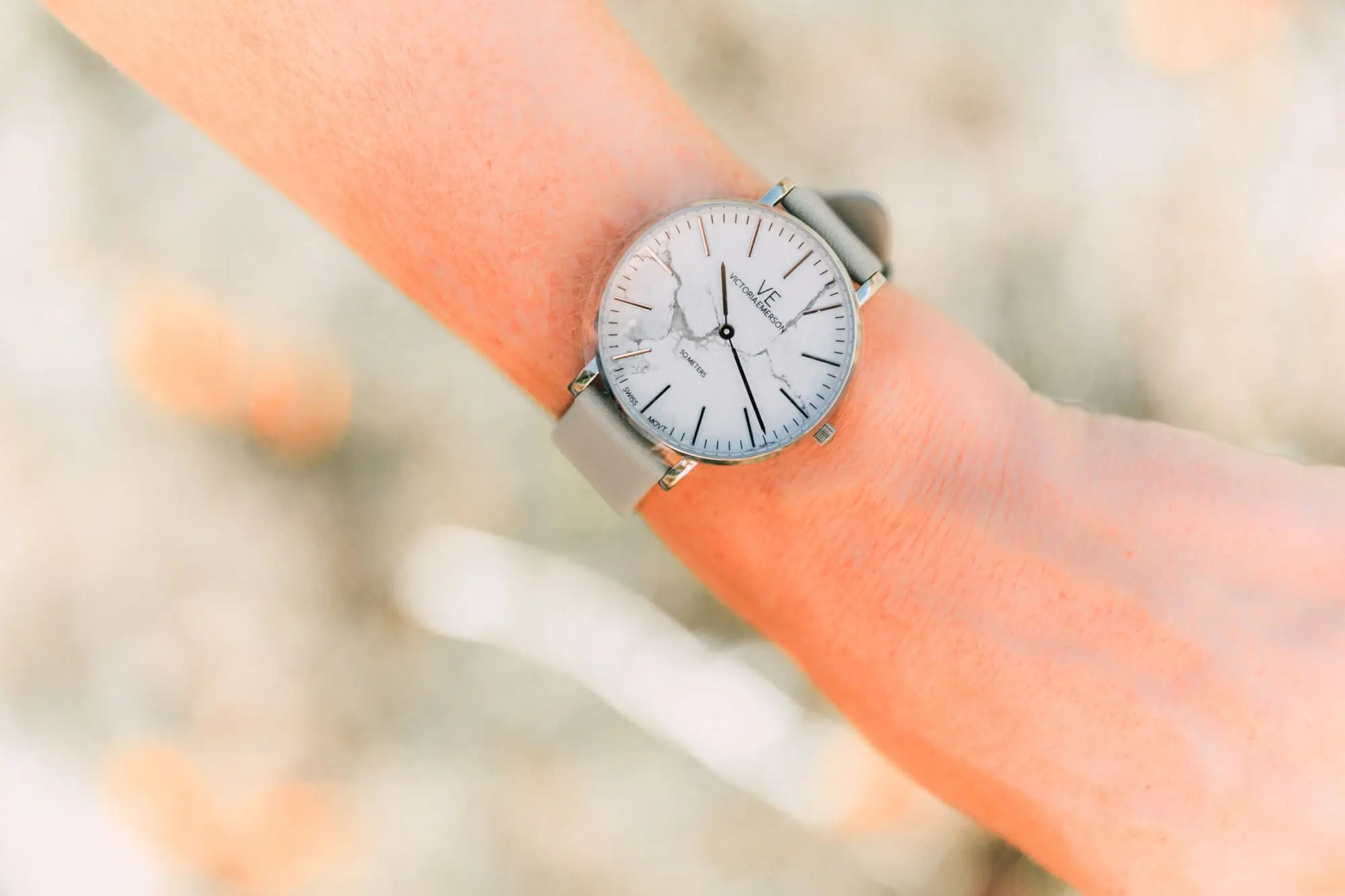 Victoria Emerson, Fashion blogger Erin Busbee of BusbeeStyle.com wearing a marble face watch, pearl wrap bracelet, brown leather wrap bracelet, and Cairo cuff from Victoria Emerson in Telluride, CO