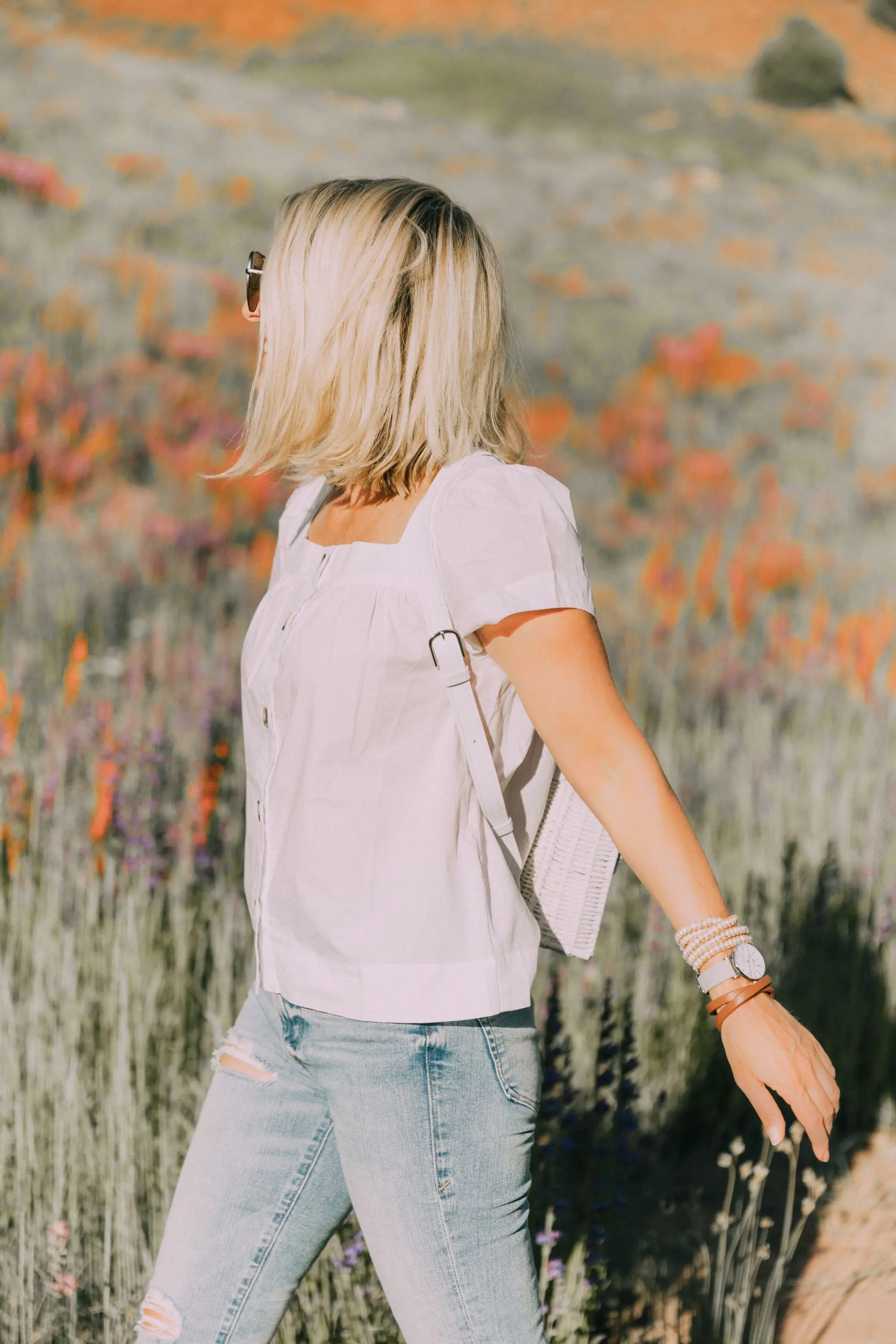 Victoria Emerson, Fashion blogger Erin Busbee of BusbeeStyle.com wearing a marble face watch, pearl wrap bracelet, brown leather wrap bracelet, and Cairo cuff from Victoria Emerson in Telluride, CO