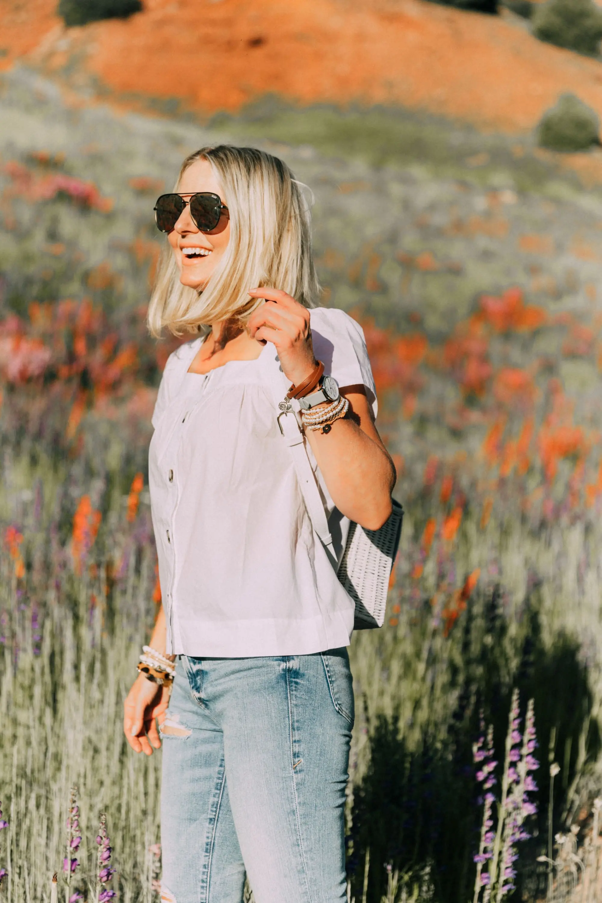 Victoria Emerson, Fashion blogger Erin Busbee of BusbeeStyle.com wearing a marble face watch, pearl wrap bracelet, brown leather wrap bracelet, and Cairo cuff from Victoria Emerson in Telluride, CO