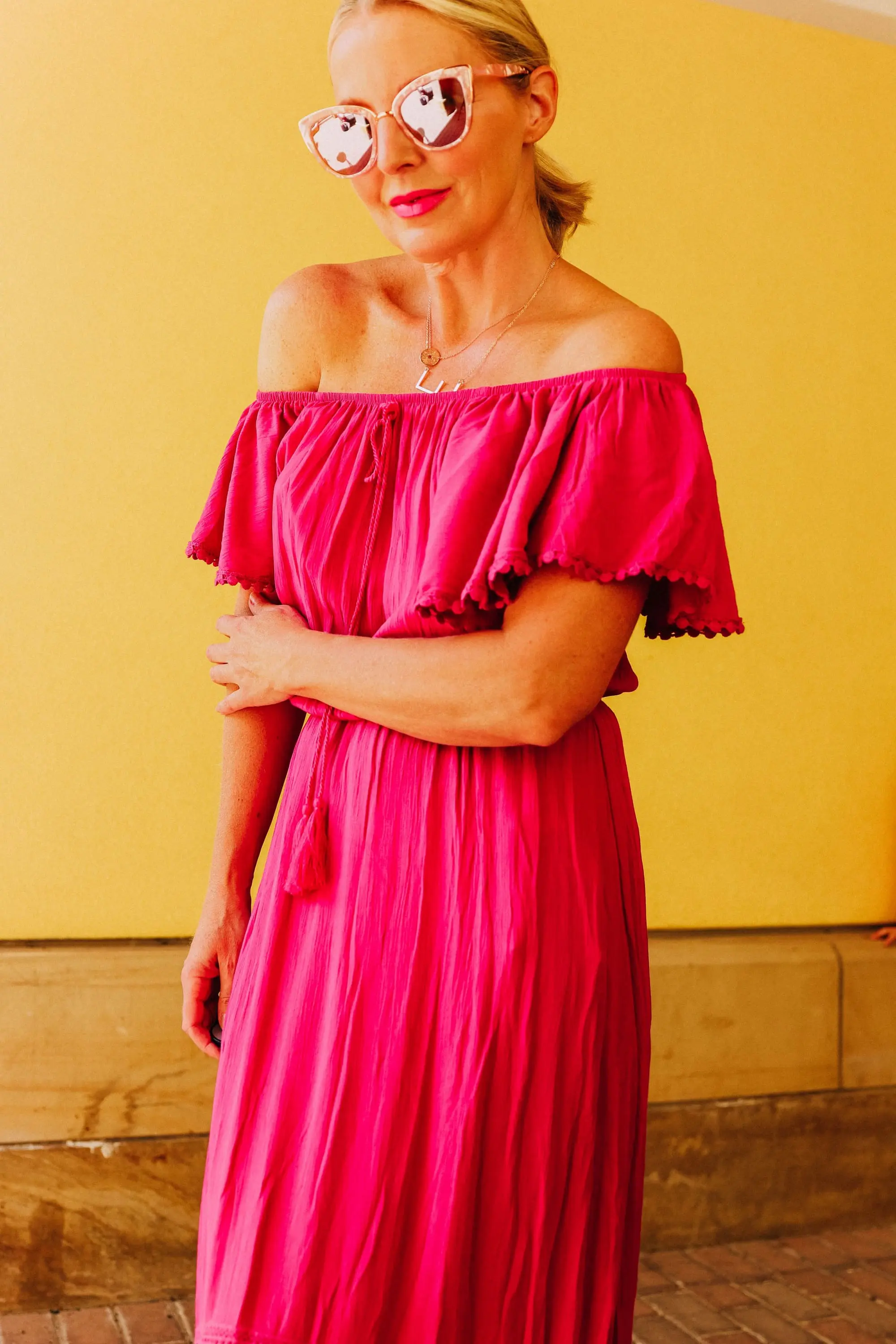 Affordable Swimwear, Fashion blogger Erin Busbee of BusbeeStyle.com wearing a pink high-low off the shoulder dress with metallic strappy sandals from Walmart
