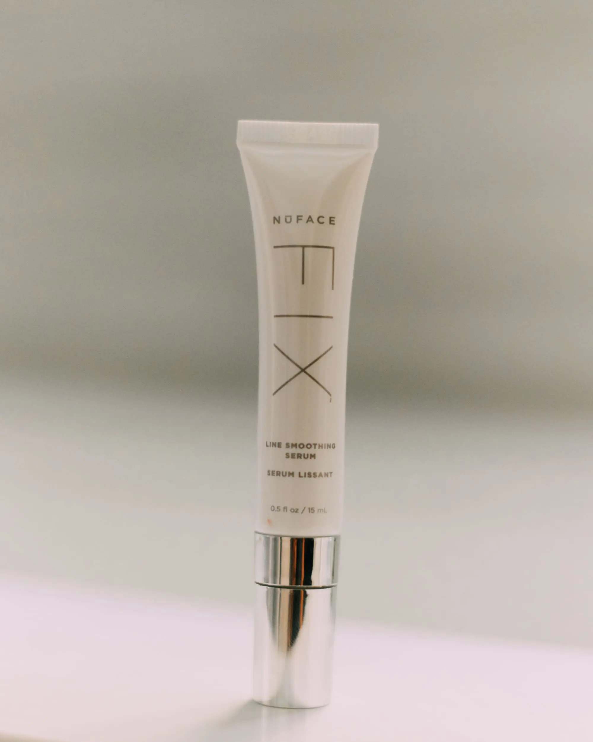 NuFace Fix, Fashion Blogger Erin Busbee of BusbeeStyle.com featuring the NuFace Fix and Serum, using it around her eye area to reduce fine lines in bathroom in Telluride, CO