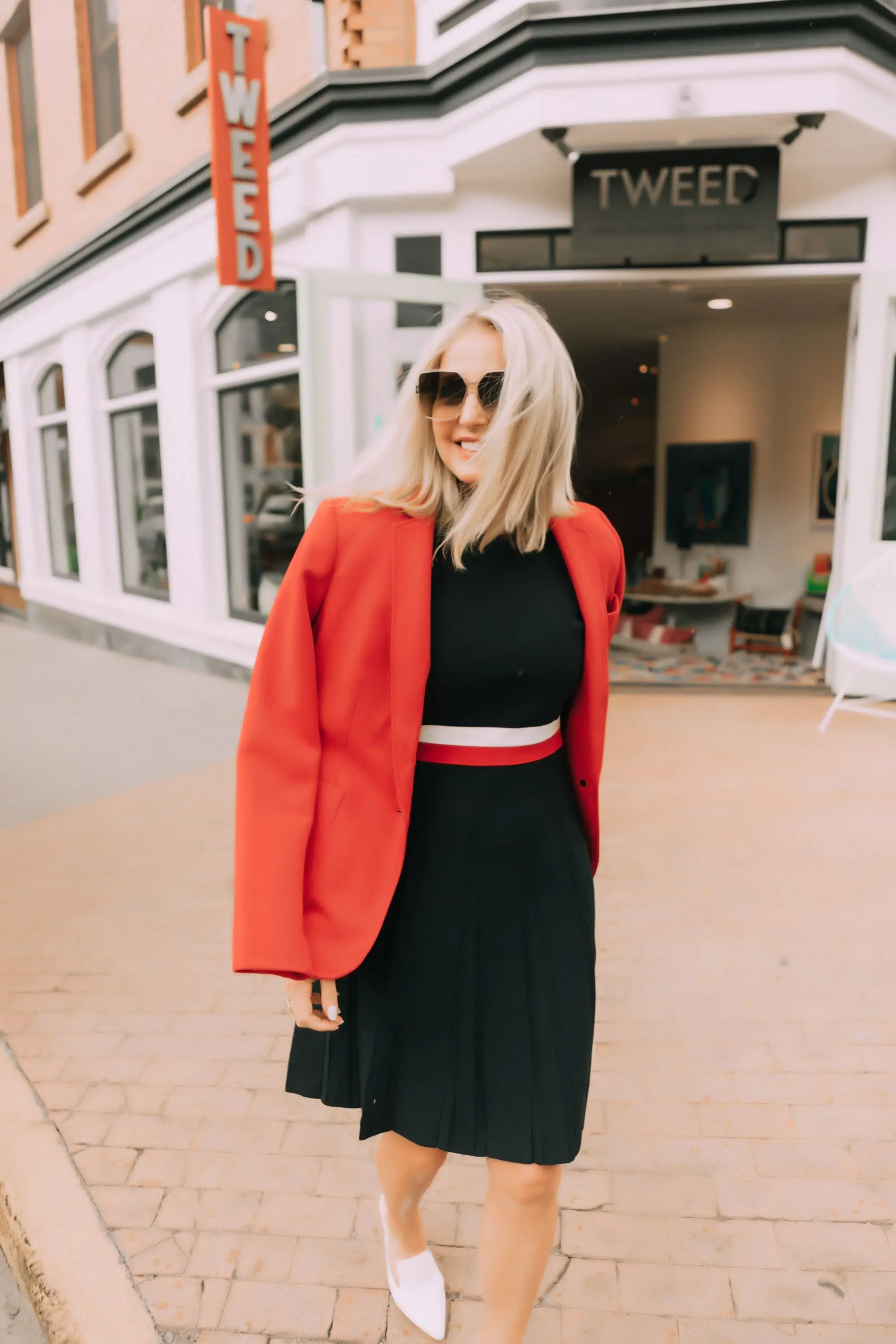 Colorful Office Outfits, Fashion blogger Erin Busbee of BusbeeStyle.com wearing a red knit blazer and navy striped fit and flare dress by Tommy Hilfiger in Telluride, CO