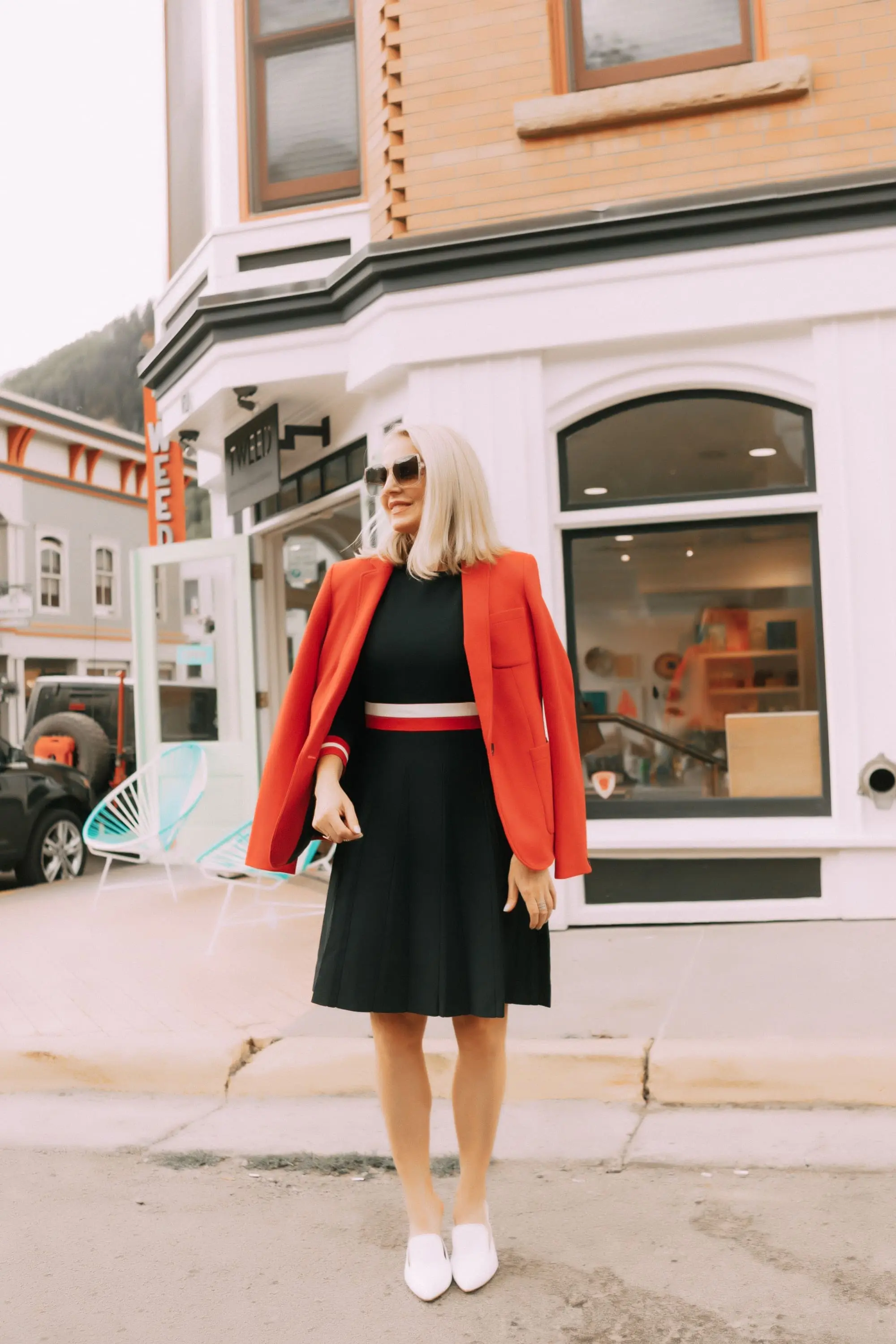 Colorful Office Outfits, Fashion blogger Erin Busbee of BusbeeStyle.com wearing a red knit blazer and navy striped fit and flare dress by Tommy Hilfiger in Telluride, CO