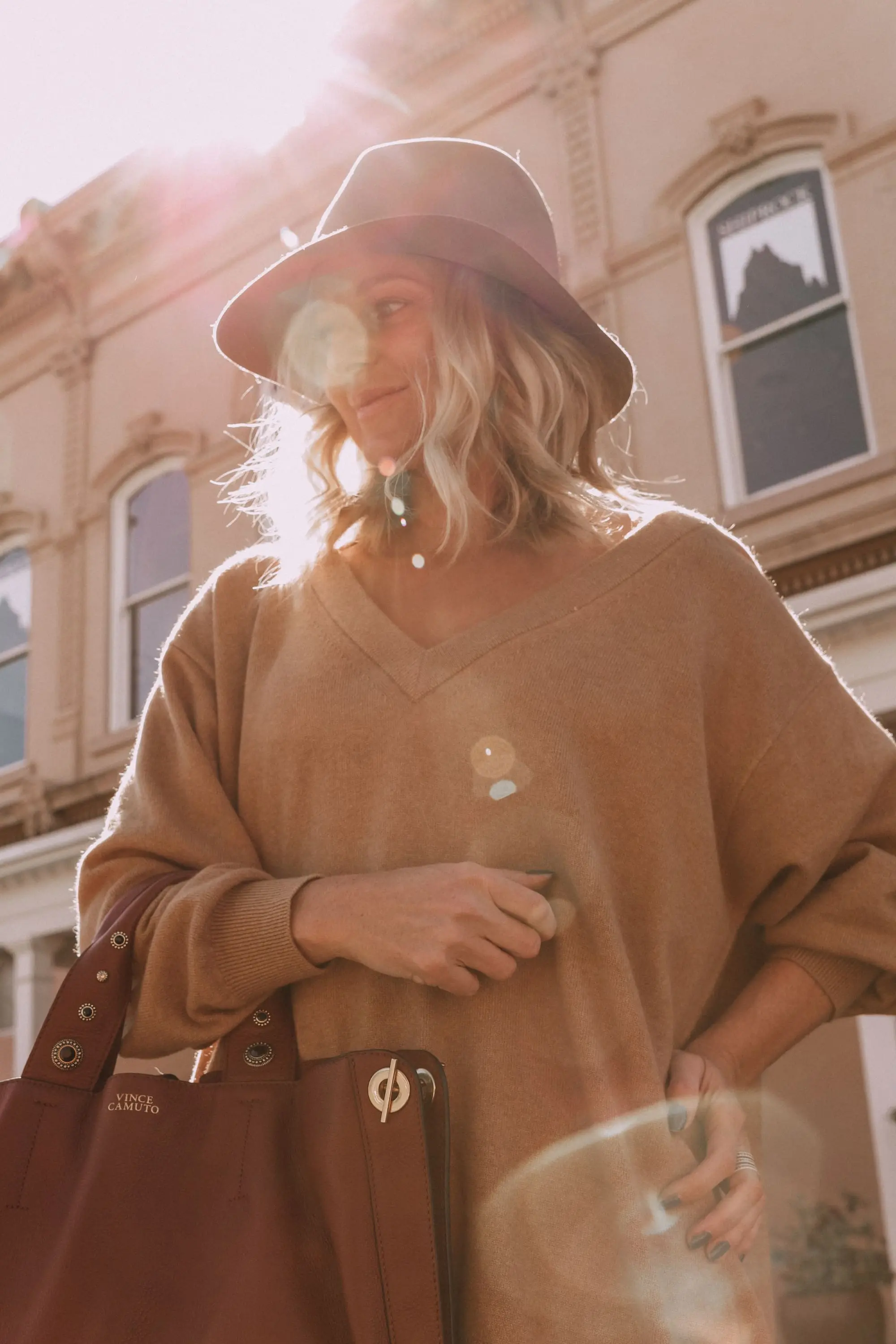 Brown Accessories For Fall, Fashion blogger Erin Busbee of BusbeeStyle.com wearing brown boots and brown tote from Vince Camuto with white jeans, camel sweater, leopard scarf, and Rag & bone hat in Santa Fe, New Mexico