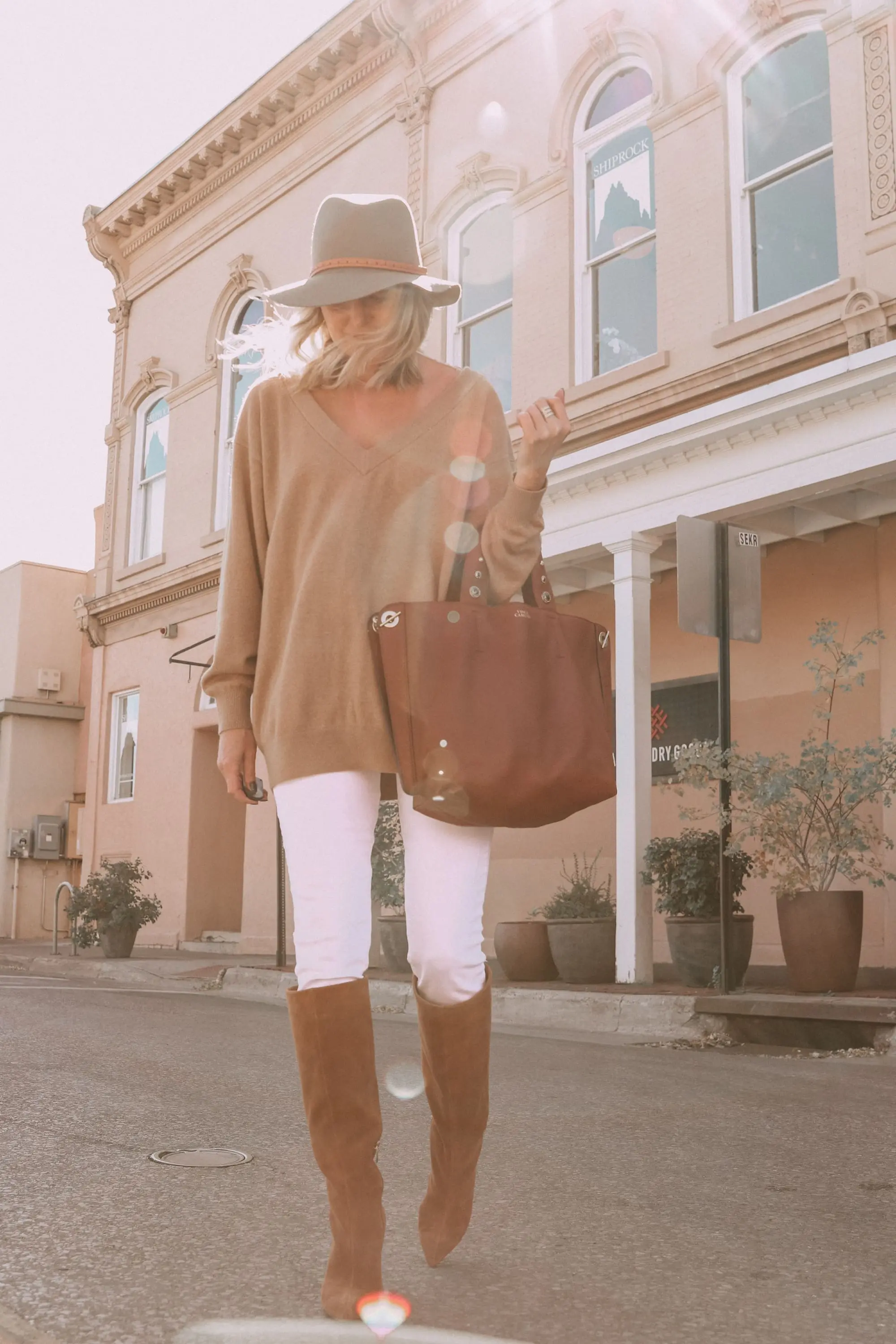 Brown Accessories For Fall, Fashion blogger Erin Busbee of BusbeeStyle.com wearing brown boots and brown tote from Vince Camuto with white jeans, camel sweater, leopard scarf, and Rag & bone hat in Santa Fe, New Mexico