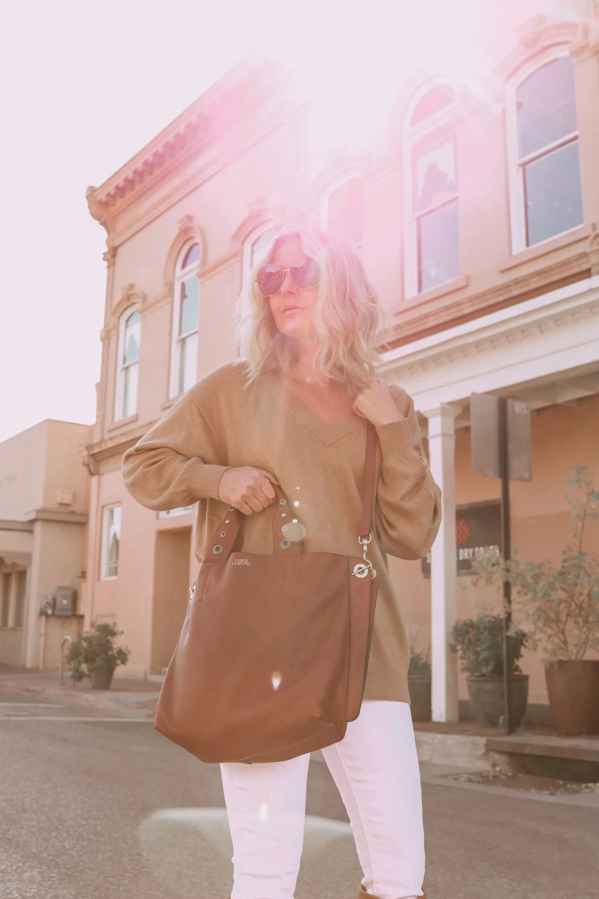 Brown Accessories For Fall, Fashion blogger Erin Busbee of BusbeeStyle.com wearing brown boots and brown tote from Vince Camuto with white jeans, camel sweater, leopard scarf, and Rag & bone hat in Santa Fe, New Mexico