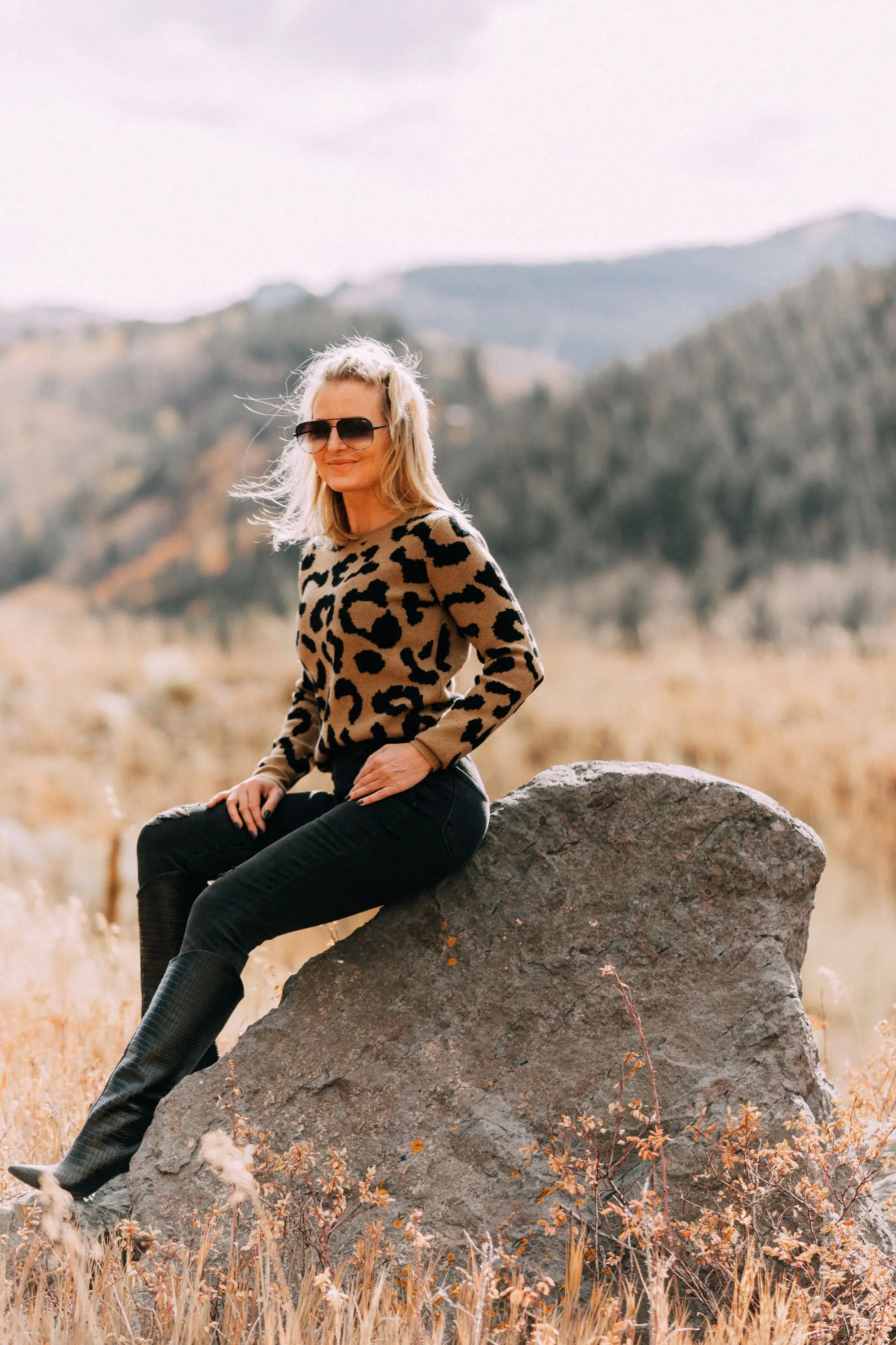 madeleine thompson leopard print crewneck sweater outfit with Schutz Maryana black Snake-Embossed High-Heel Boots