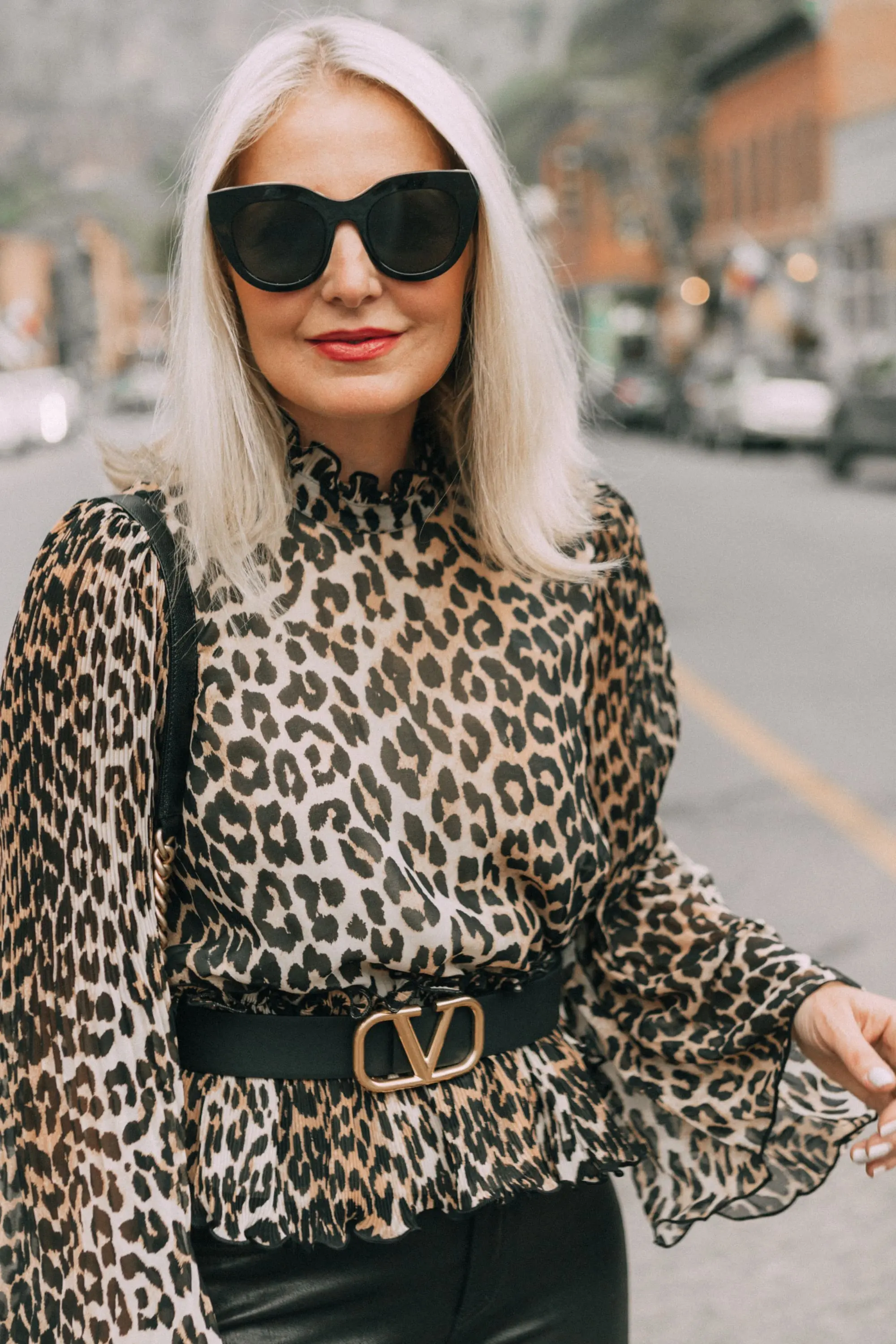high neckline leopard print Ganni mock neck blouse black trousers valentino gold belt