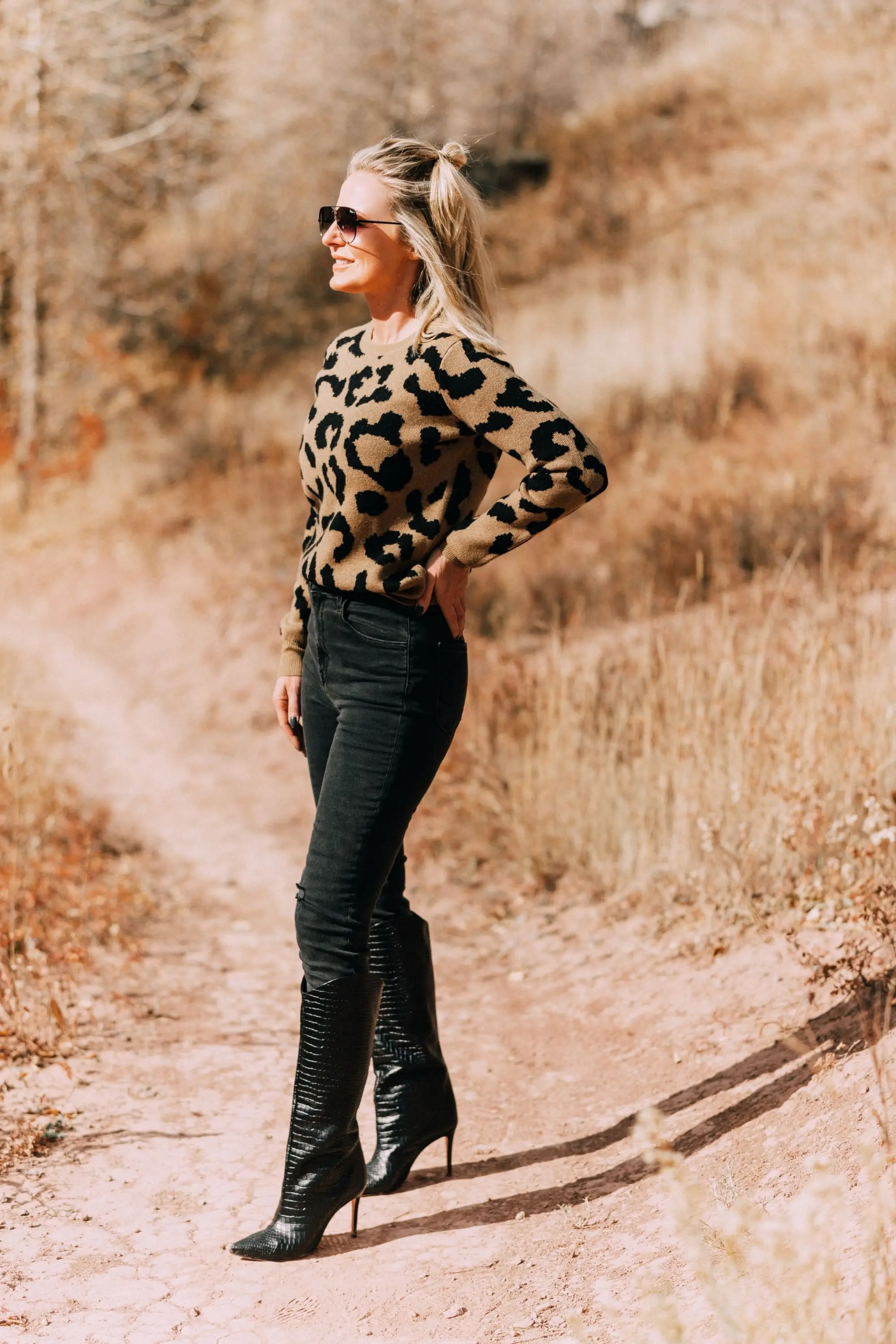 madeleine thompson leopard print crewneck sweater outfit with Schutz Maryana black Snake-Embossed High-Heel Boots
