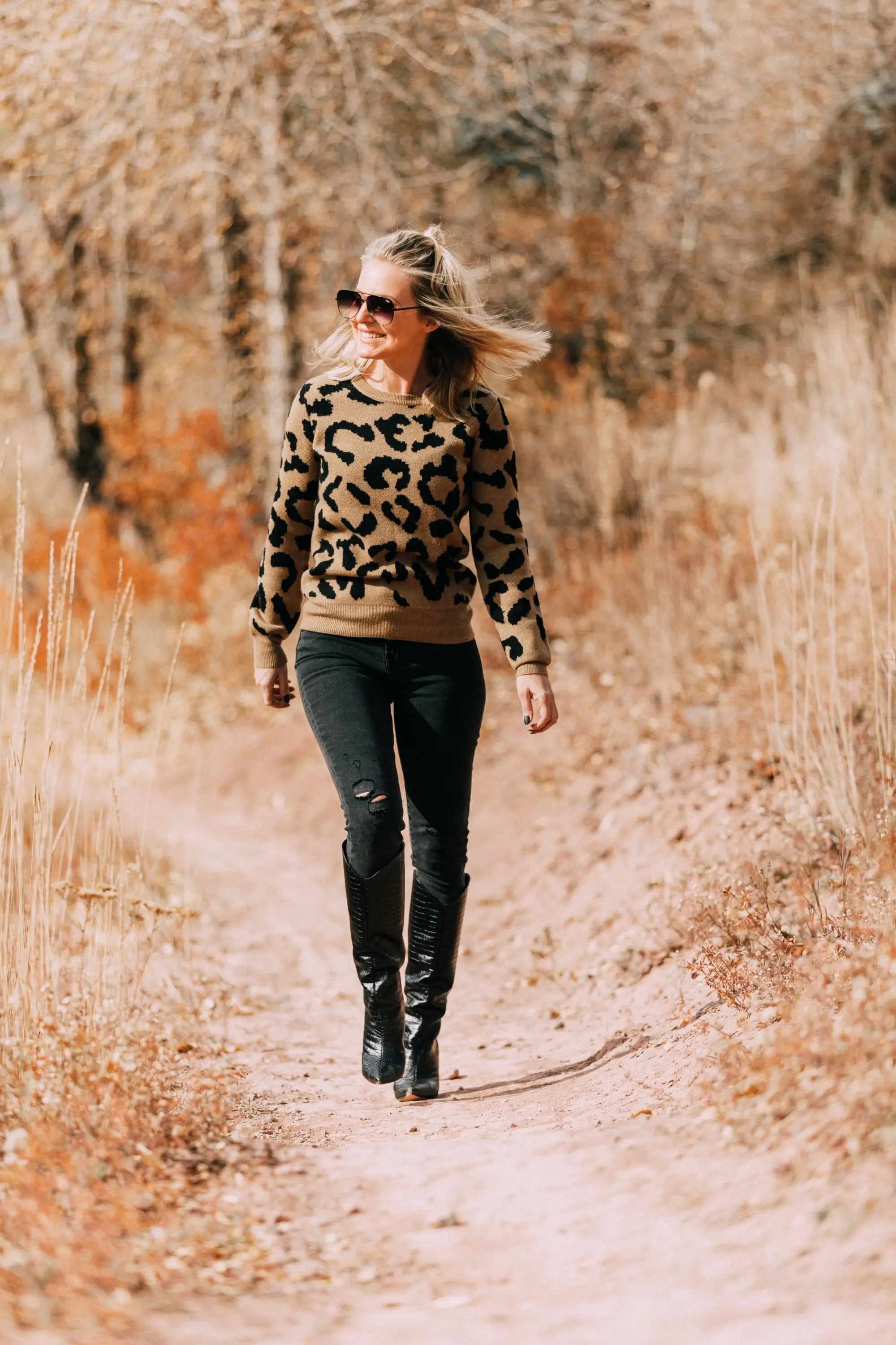 madeleine thompson leopard print crewneck sweater outfit with Schutz Maryana black Snake-Embossed High-Heel Boots