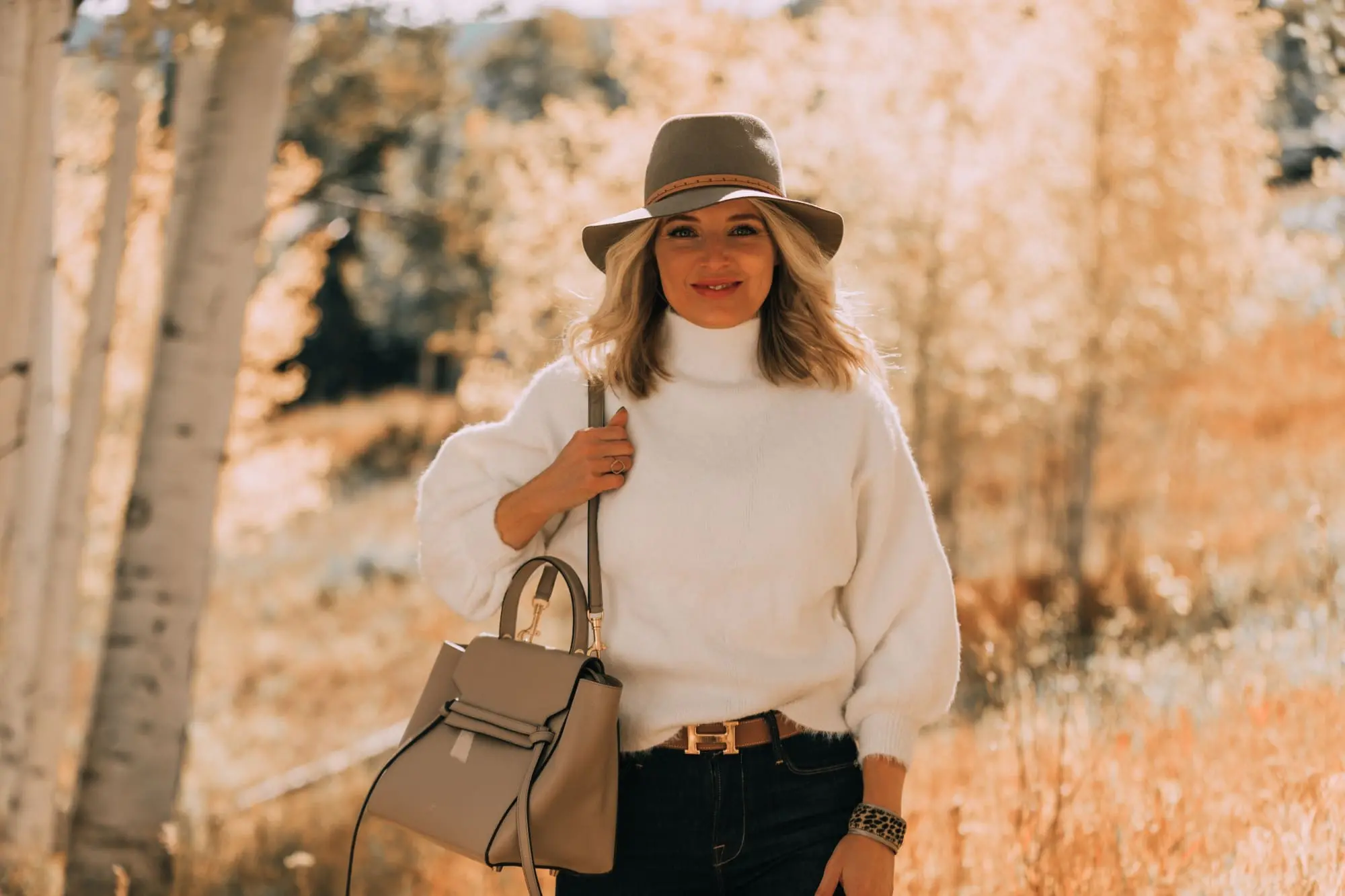 Fuzzy Sweaters, Fashion blogger Erin Busbee of BusbeeStyle.com wearing a white fuzzy sweater by Line & Dot with rag & bone skinny jeans, brown knee high boots, celine belt bag, and treasure & bond floppy brim hat in Telluride, Colorado