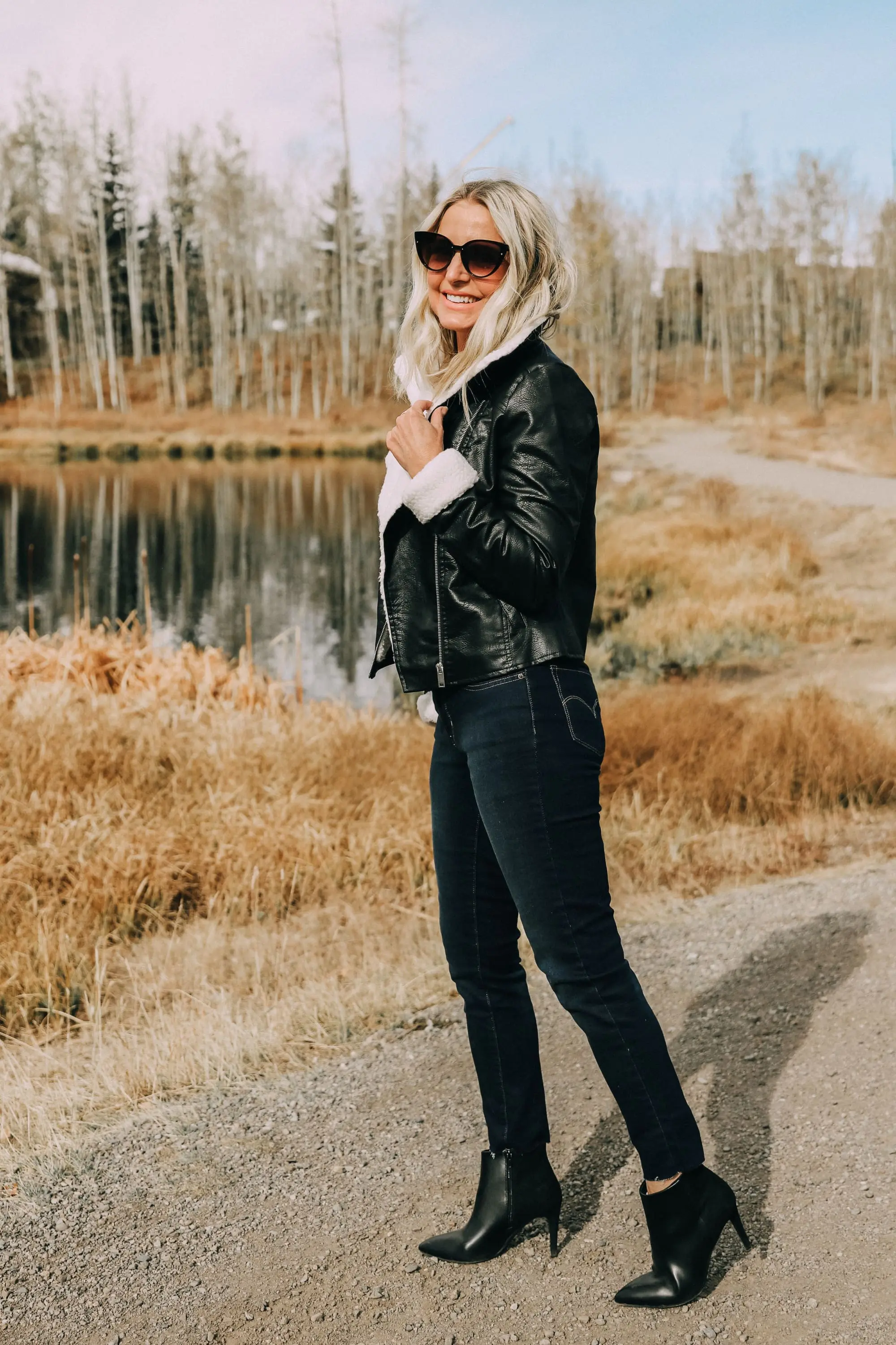 fashion blogger erin busbee wearing affordable black moto jacket with faux fur lining dark wash levis 711 skinny jeans black heeled booties from jcpenney