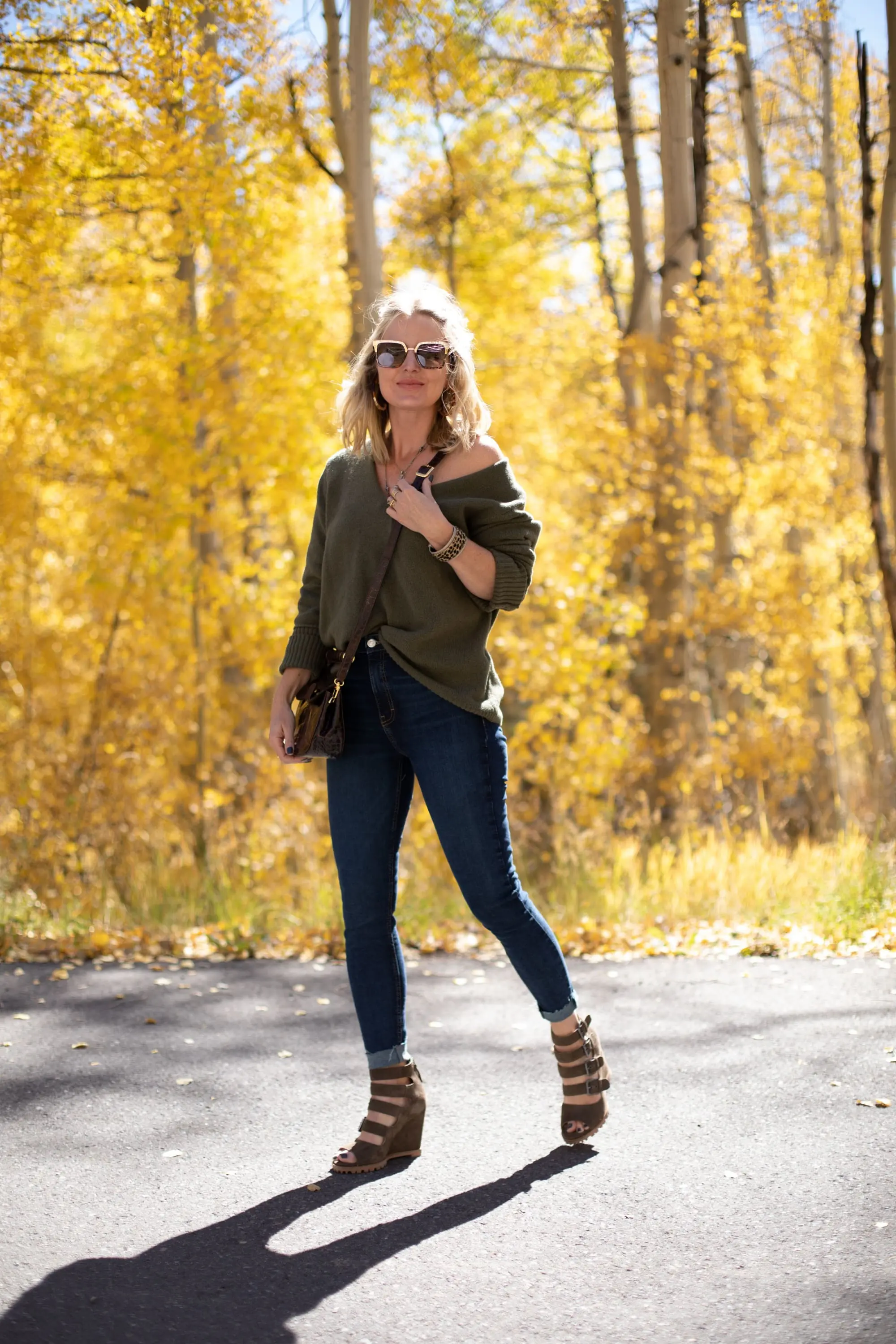 Shoes For Busy Women, Fashion blogger Erin Busbee of BusbeeStyle.com wearing Linea Paolo Wisteria Buckle Wedge Sandals with rag & bone skinny jeans, Something Navy green sweater, Staud Madeline Croc Embossed crossbody, and Quay sunglasses in Telluride, CO