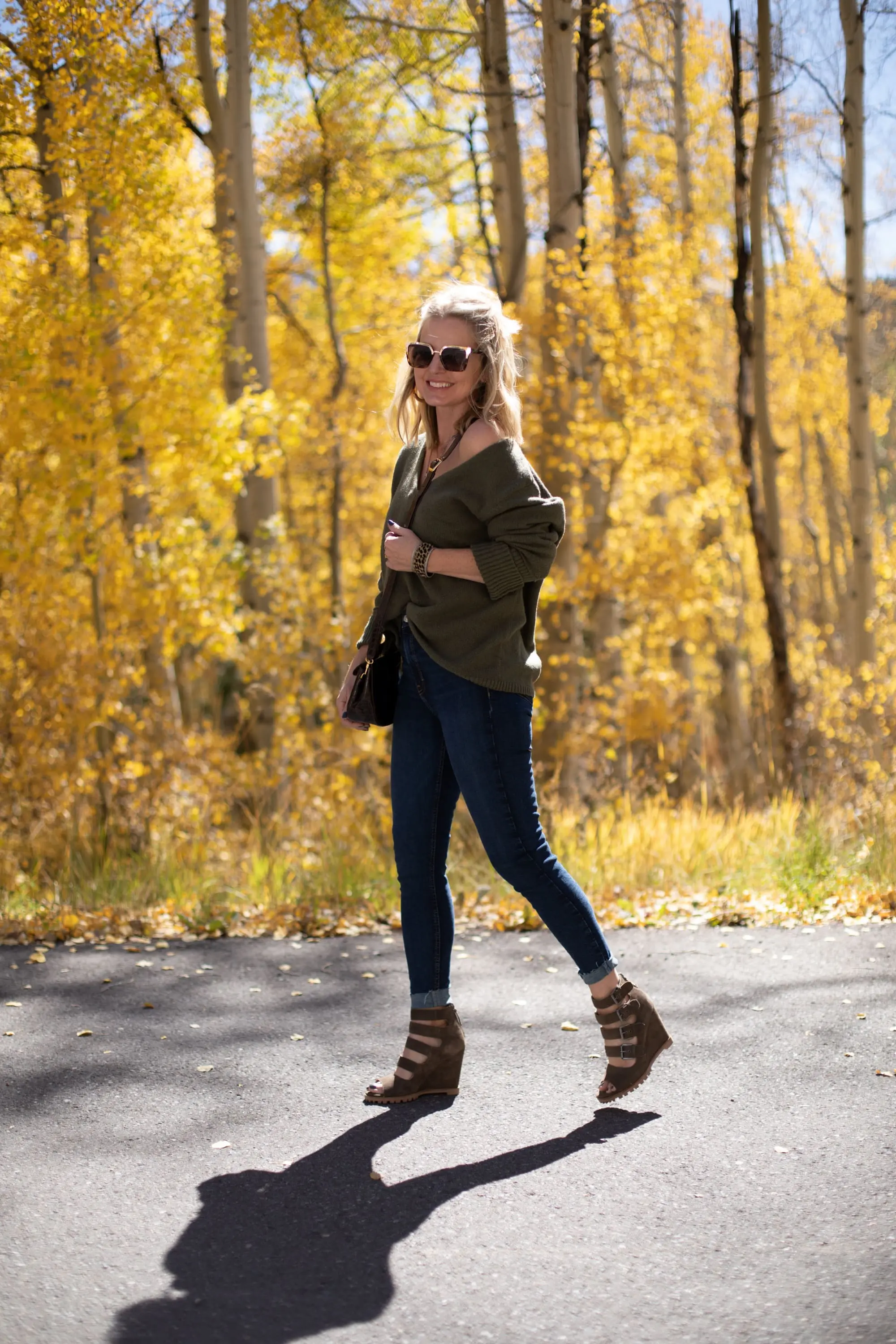 Shoes For Busy Women, Fashion blogger Erin Busbee of BusbeeStyle.com wearing Linea Paolo Wisteria Buckle Wedge Sandals with rag & bone skinny jeans, Something Navy green sweater, Staud Madeline Croc Embossed crossbody, and Quay sunglasses in Telluride, CO