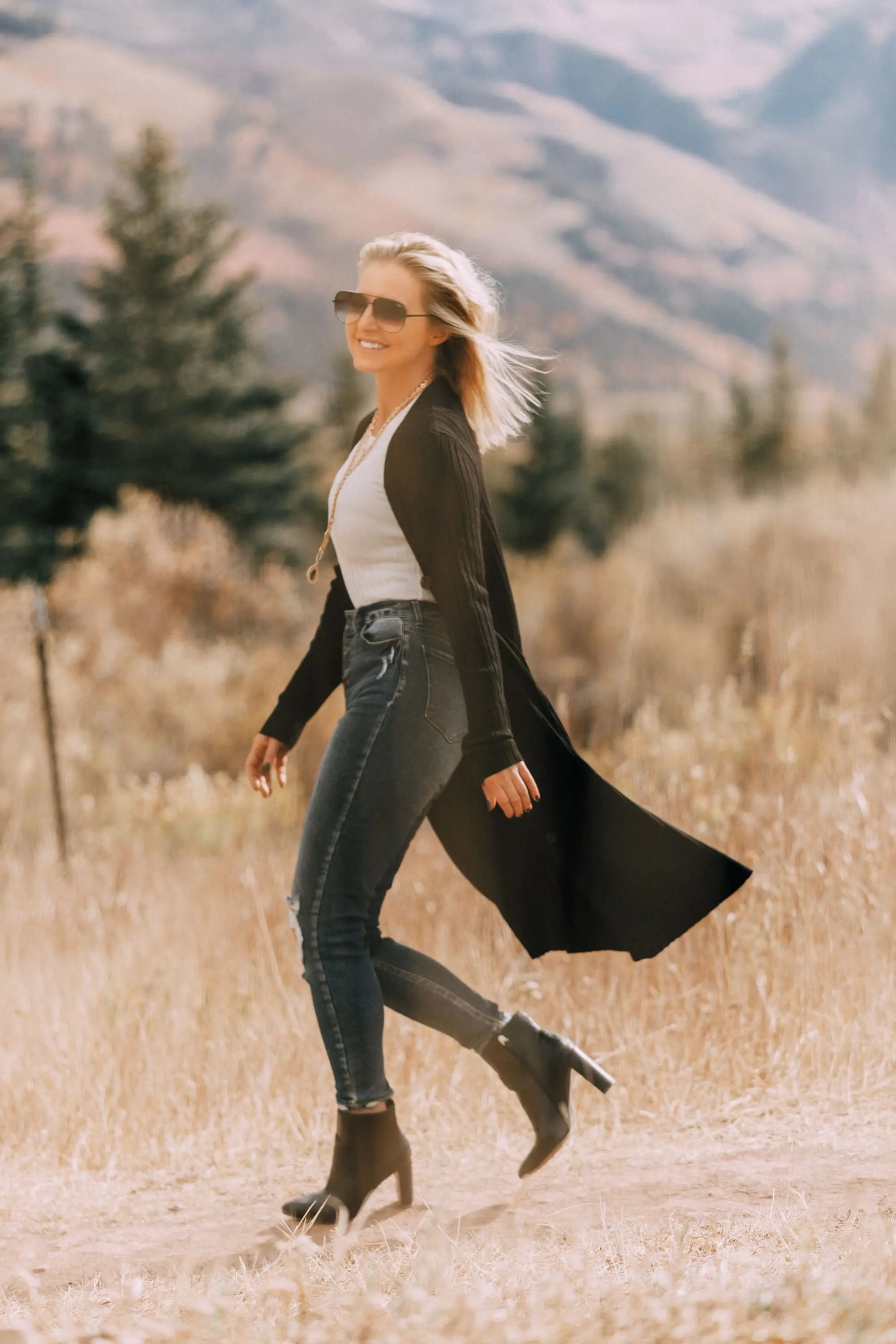 Long Cardigan, Fashion blogger Erin Busbee of BusbeeStyle.com wearing ripped skinny jeans by Levi's with snake embossed booties by Scoop, a white ribbed sweater, and black ribbed cardigan from Walmart in Telluride, CO