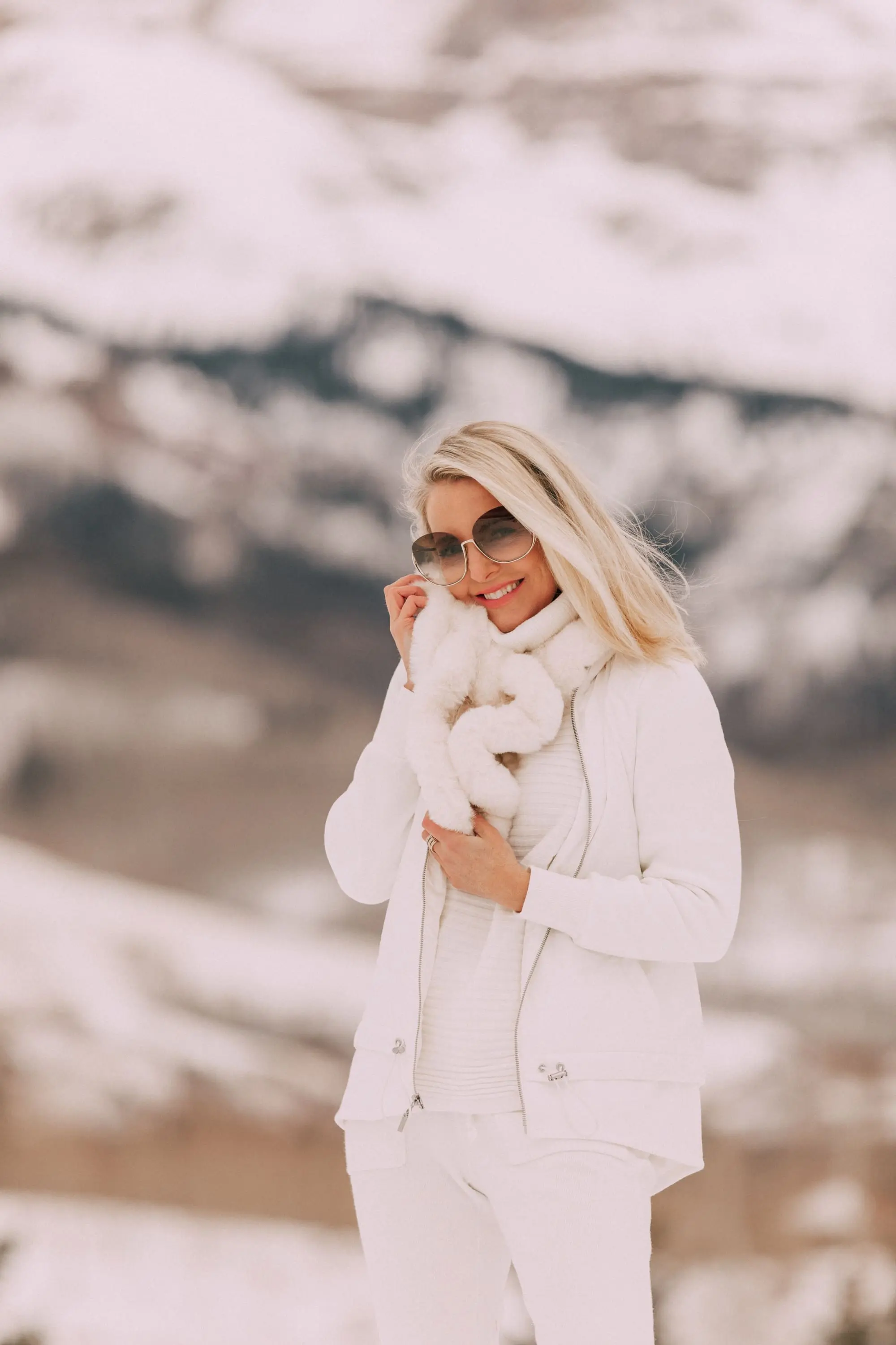 Elegant Loungewear, Fashion blogger Erin Busbee of BusbeeStyle.com wearing a white ribbed cashmere blend sweater, white cashmere blend joggers, white quilted and fleece jacket, and white faux fur scarf from Chico's and brown faux fur boots in Telluride, Colorado