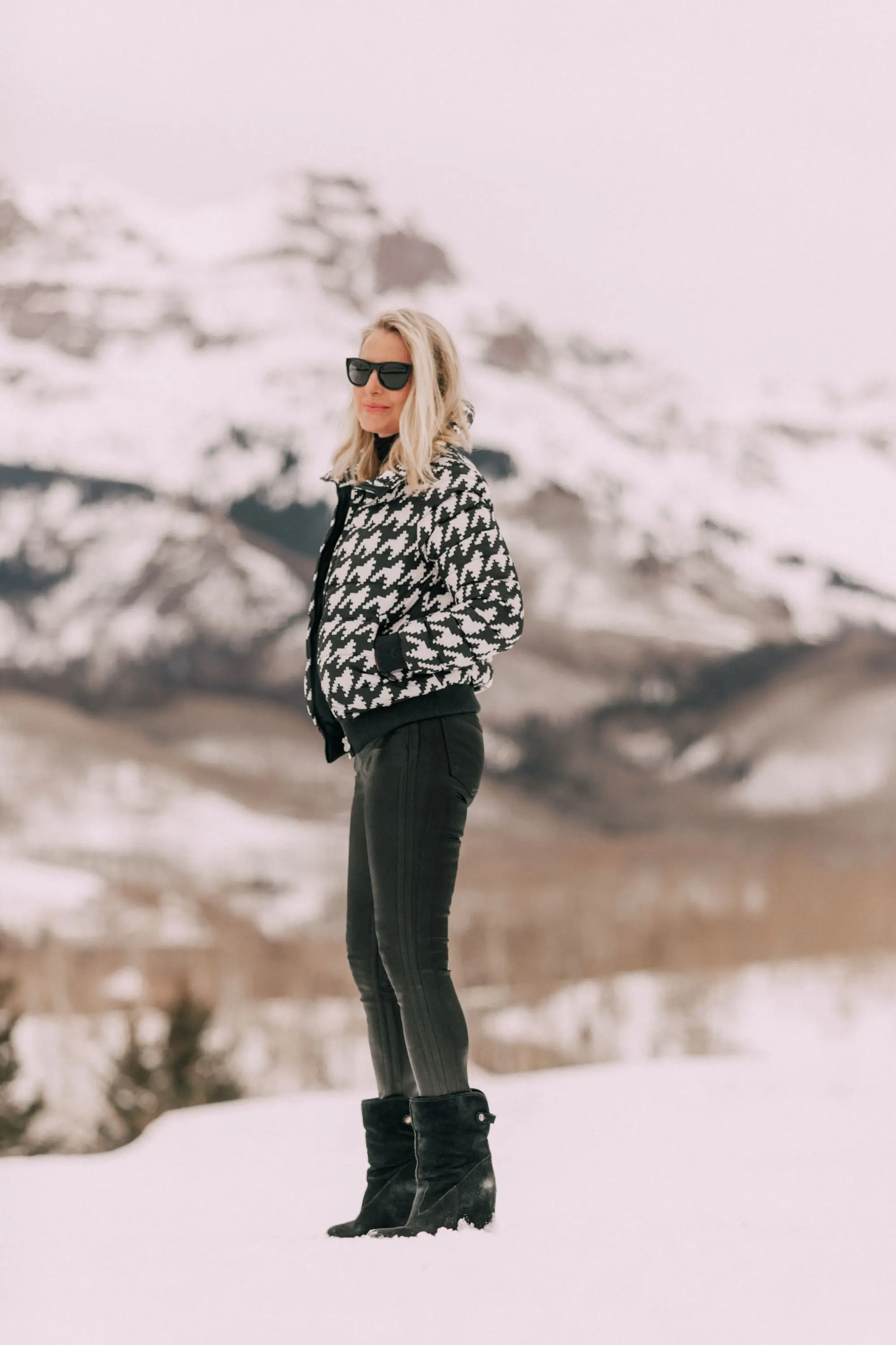 stylish puffer coat outfit, Fashion blogger over 40 wearing Perfect Moment houndstooth puffer jacket, black Citizens of Humanity Rocket leatherette Skinny Jeans with a black cashmere turtleneck sweater by Aqua, in snow in Telluride, CO