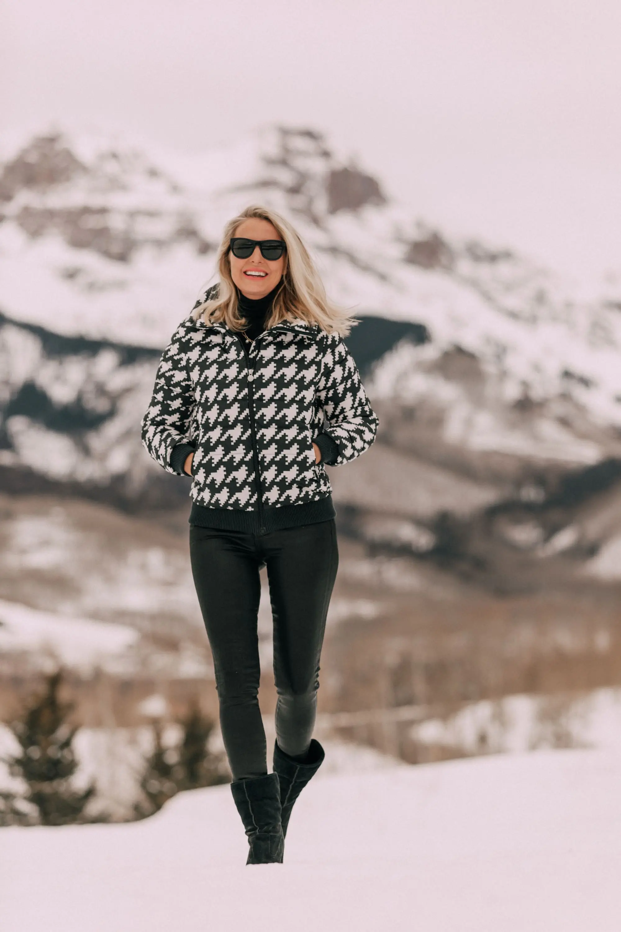 Chic Ski Brand, Fashion blogger Erin Busbee of BusbeeStyle.com wearing black Rocket leatherette Skinny Jeans by Citizens of Humanity with a black cashmere turtleneck sweater by Aqua, and a houndstooth puffer jacket by Perfect Moment from Shopbop, and Ugg wedge boots in the snow in Telluride, CO