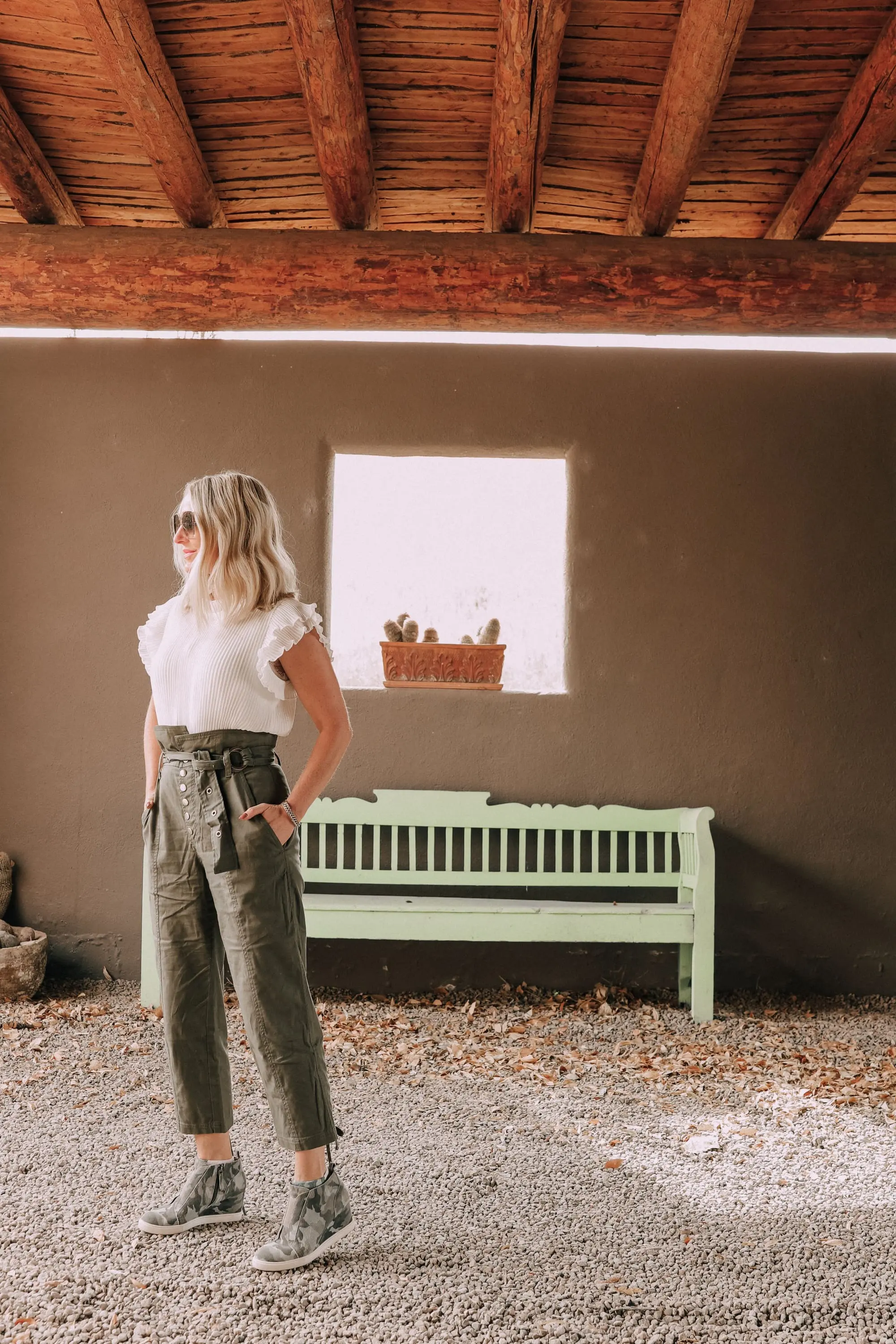 Edgy Classic Style, Fashion Blogger Erin Busbee of BusbeeStyle.com wearing green Gia Pants by Marissa Webb with a white ruffle blouse by Gibson from Nordstrom with camo Linea Paolo wedge sneakers at Cibolo Creek Ranch in Texas