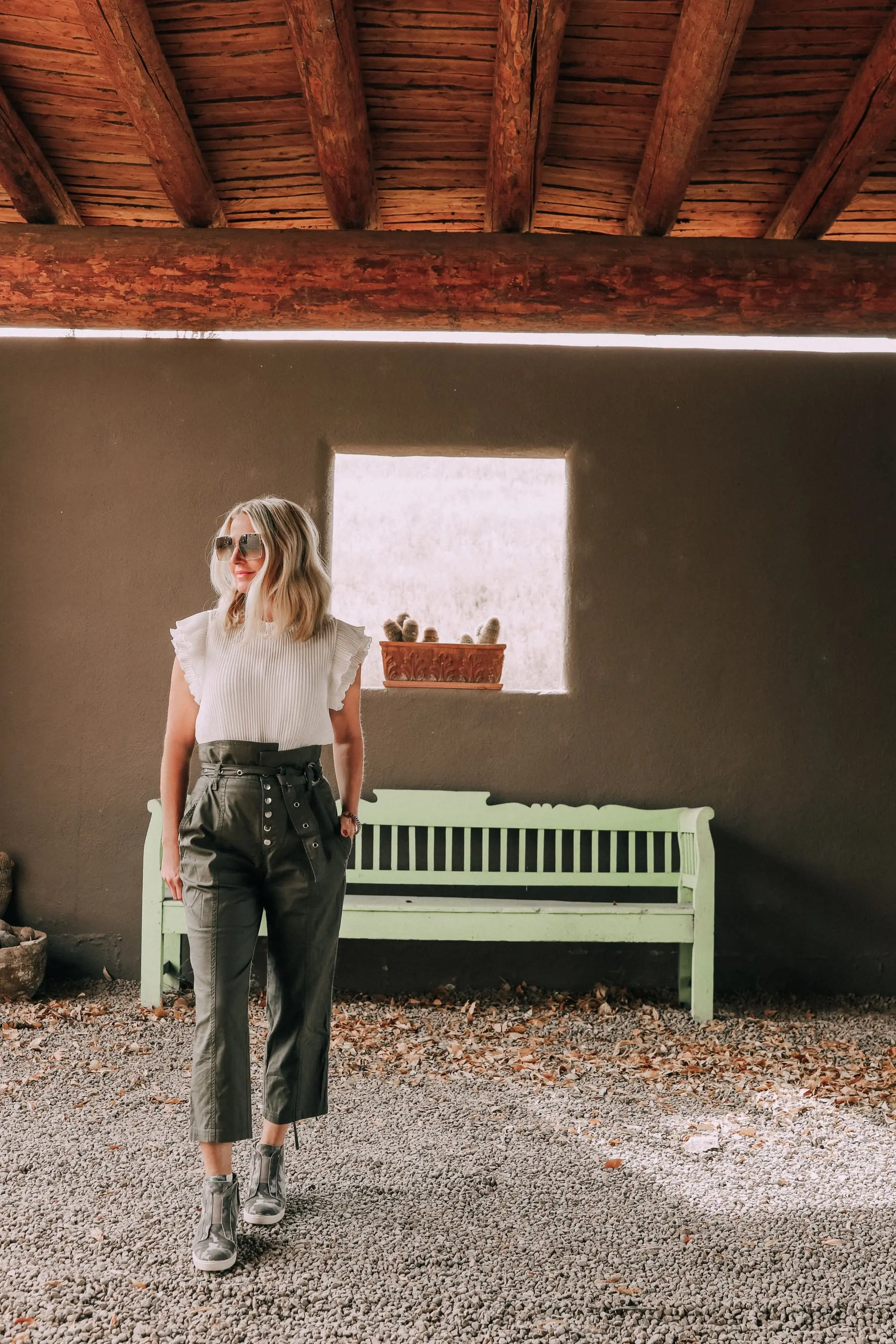 fashion blogger erin busbee wearing army green pants white ruffle blouse camo print sneakers