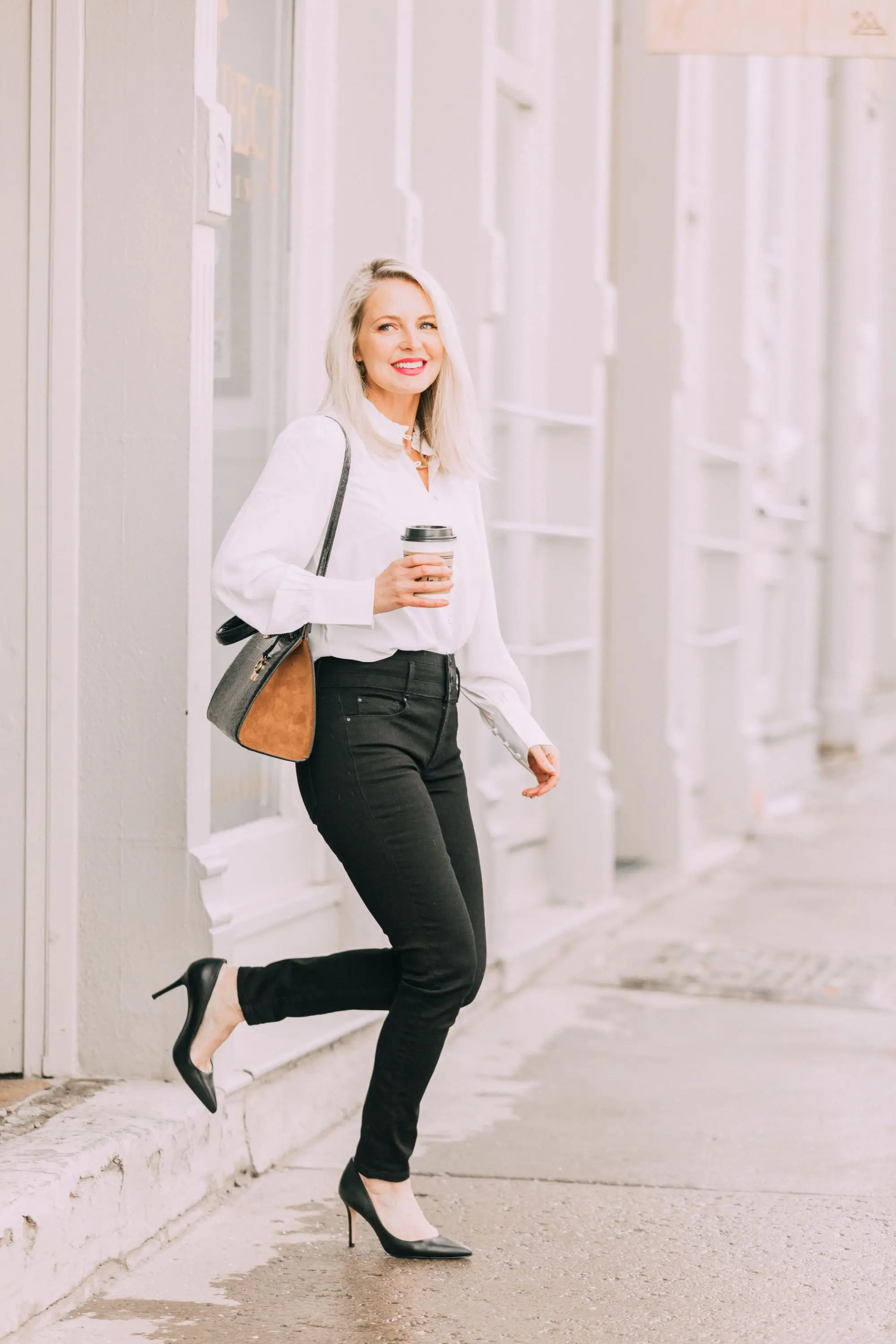 Wardrobe Basics, Fashion blogger Erin Busbee of BusbeeStyle.com wearing black pocket sculpting jeans, a white ruffle neck blouse, black pumps, bar link necklace, and cutout hoops earrings all from Ann Taylor in Telluride, Colorado
