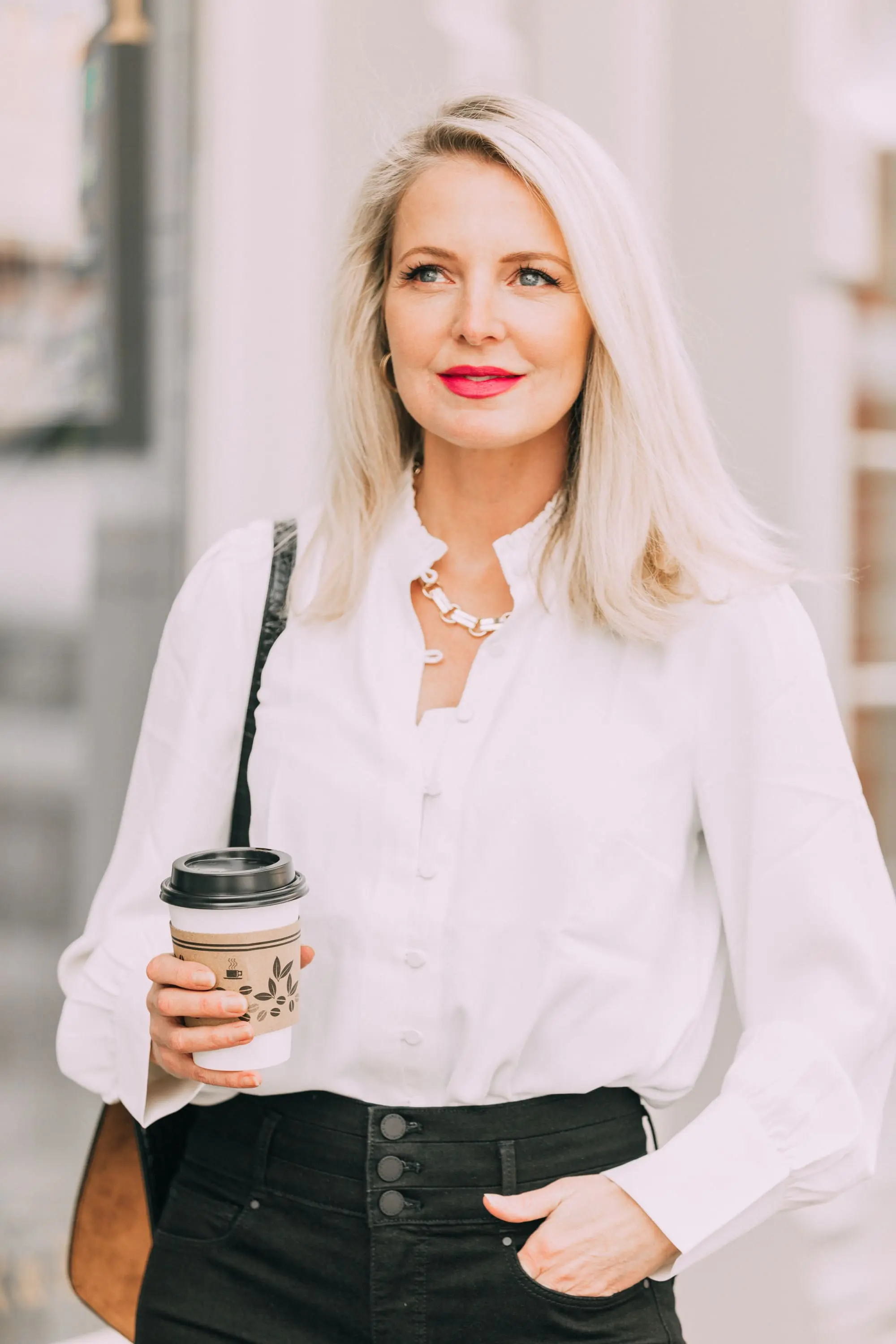 Wardrobe Basics, Fashion blogger Erin Busbee of BusbeeStyle.com wearing black pocket sculpting jeans, a white ruffle neck blouse, black pumps, bar link necklace, and cutout hoops earrings all from Ann Taylor in Telluride, Colorado