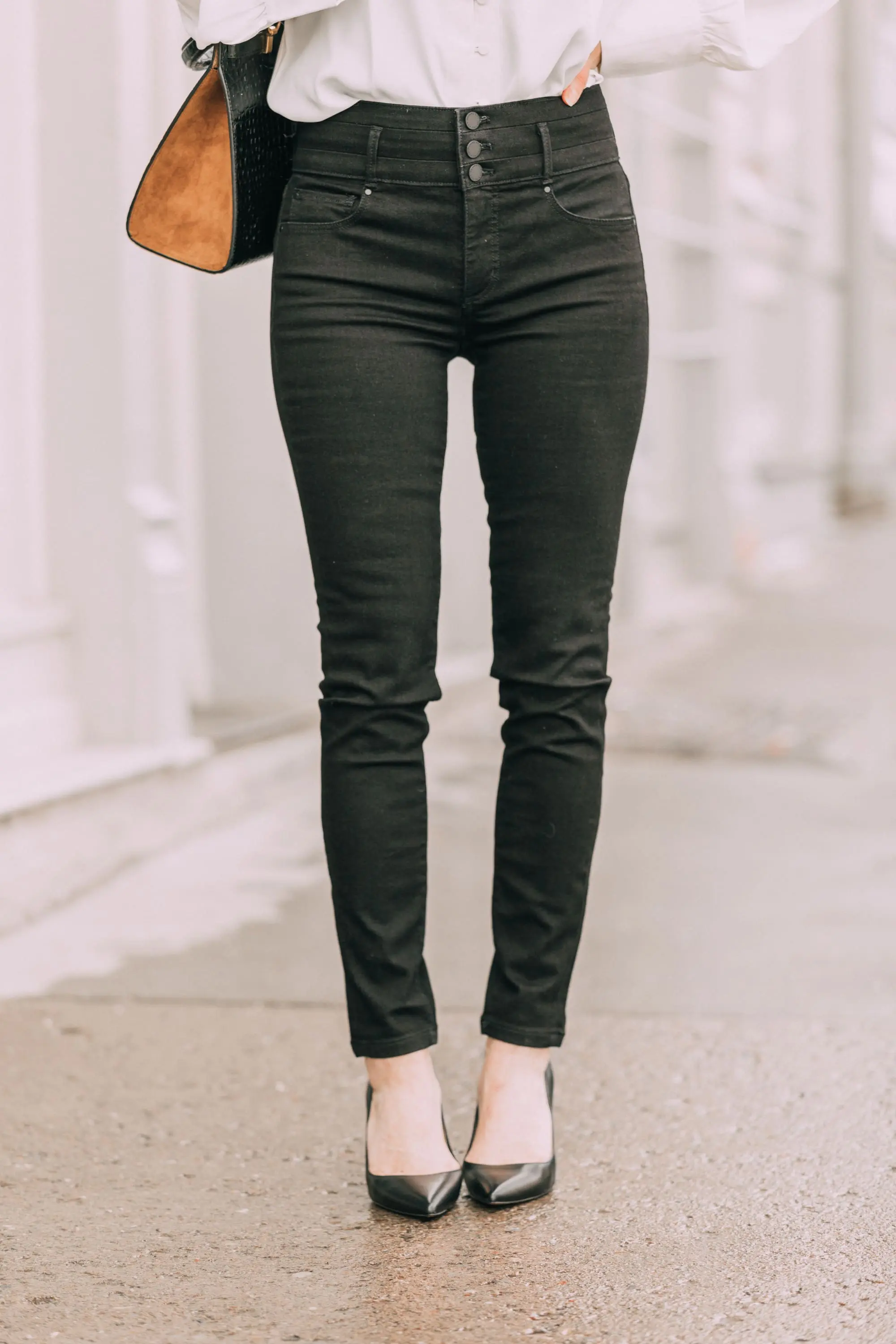 Wardrobe Basics, Fashion blogger Erin Busbee of BusbeeStyle.com wearing black pocket sculpting jeans, a white ruffle neck blouse, black pumps, bar link necklace, and cutout hoops earrings all from Ann Taylor in Telluride, Colorado