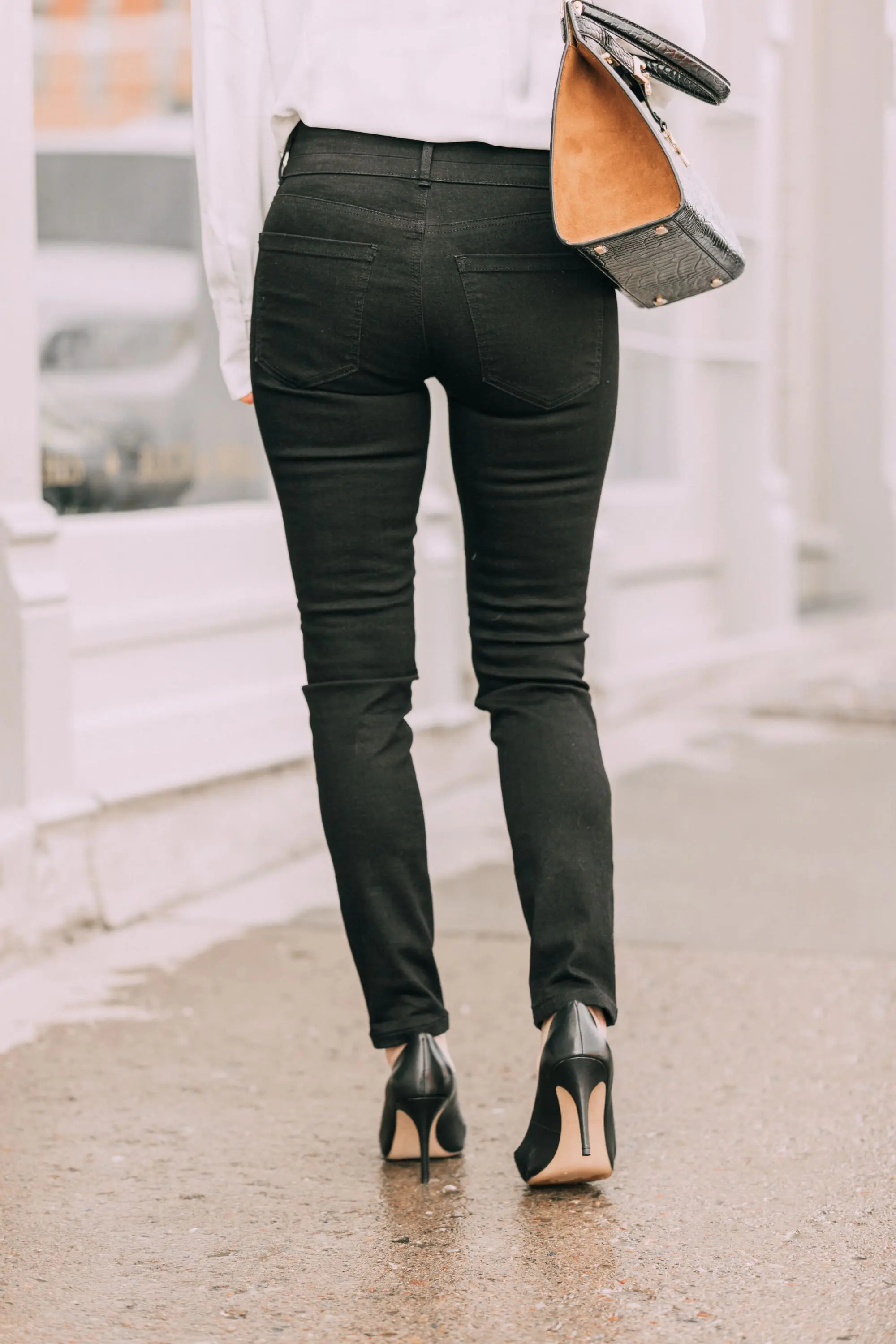 Wardrobe Basics, Fashion blogger Erin Busbee of BusbeeStyle.com wearing black pocket sculpting jeans, a white ruffle neck blouse, black pumps, bar link necklace, and cutout hoops earrings all from Ann Taylor in Telluride, Colorado