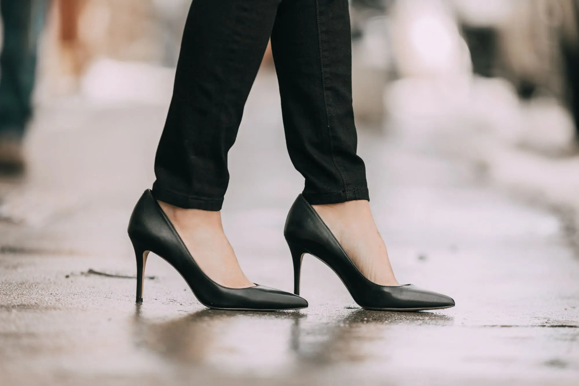Wardrobe Basics, Fashion blogger Erin Busbee of BusbeeStyle.com wearing black pocket sculpting jeans, a white ruffle neck blouse, black pumps, bar link necklace, and cutout hoops earrings all from Ann Taylor in Telluride, Colorado