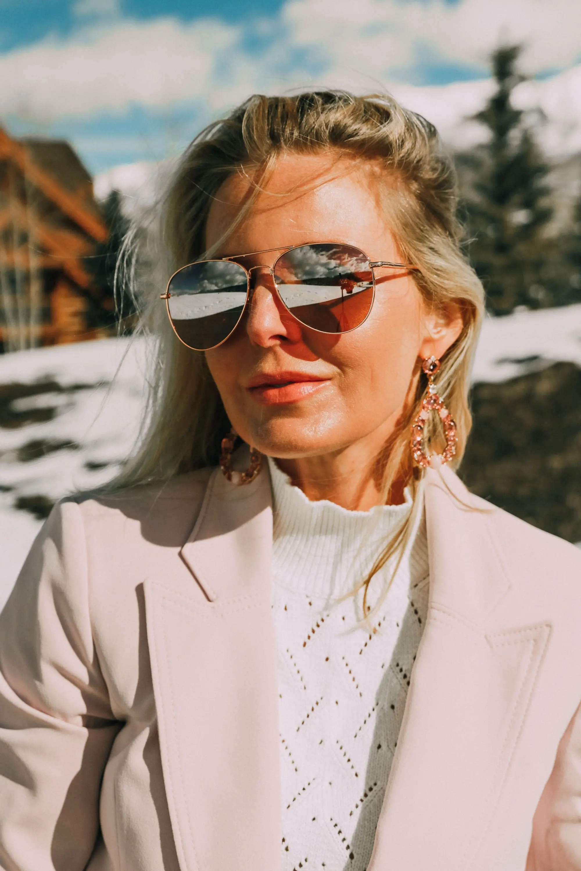 Pink Office Outfit, Fashion blogger Erin Busbee of BusbeeStyle.com wearing a pink power suit from White House Black Market, including a pink belted blazer, pink soft stretch pants, white puff sleeve sweater dress, pink pumps, pink earrings, and aviator sunglasses in Telluride, Colorado