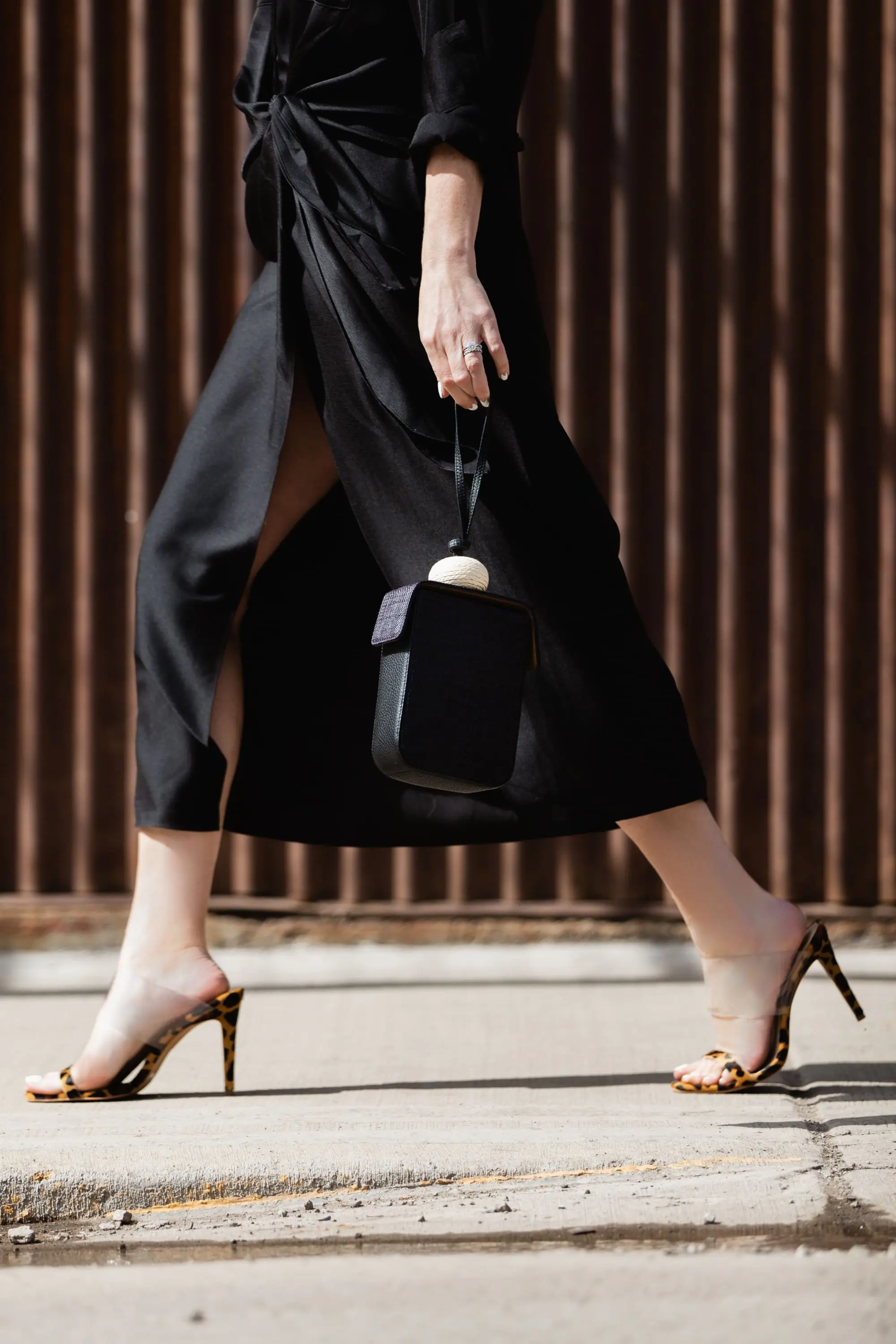 Spring Accessories, Fashion blogger Erin Busbee of BusbeeStyle.com wearing a black L'Academie shirt dress with black studded strappy slides and black bracelet bag from Vince Camuto in Telluride, Colorado