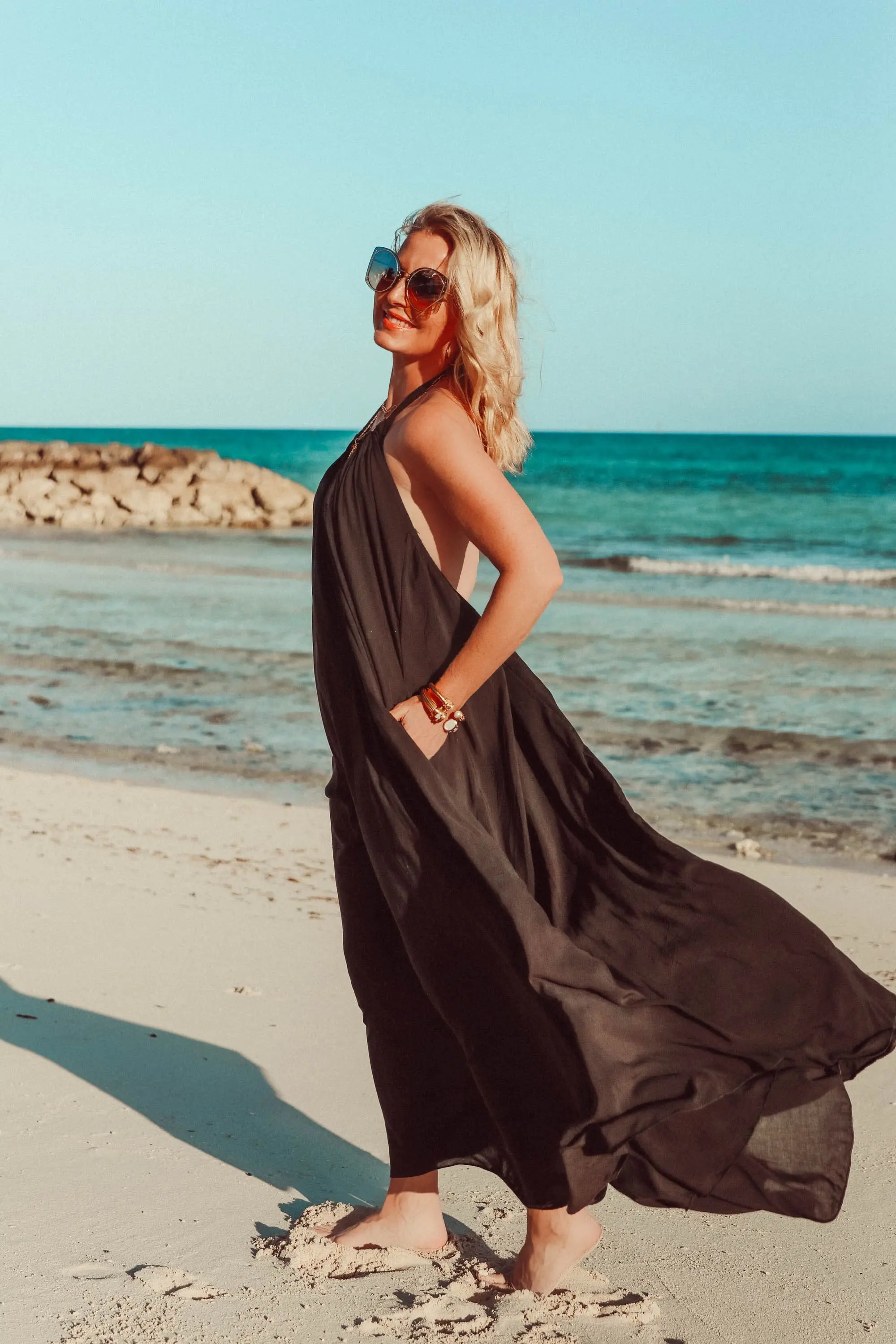 Best Coverups, Fashion blogger Erin Busbee of BusbeeStyle.com wearing a black halter neck coverup by Elan on the beach in the Bahamas