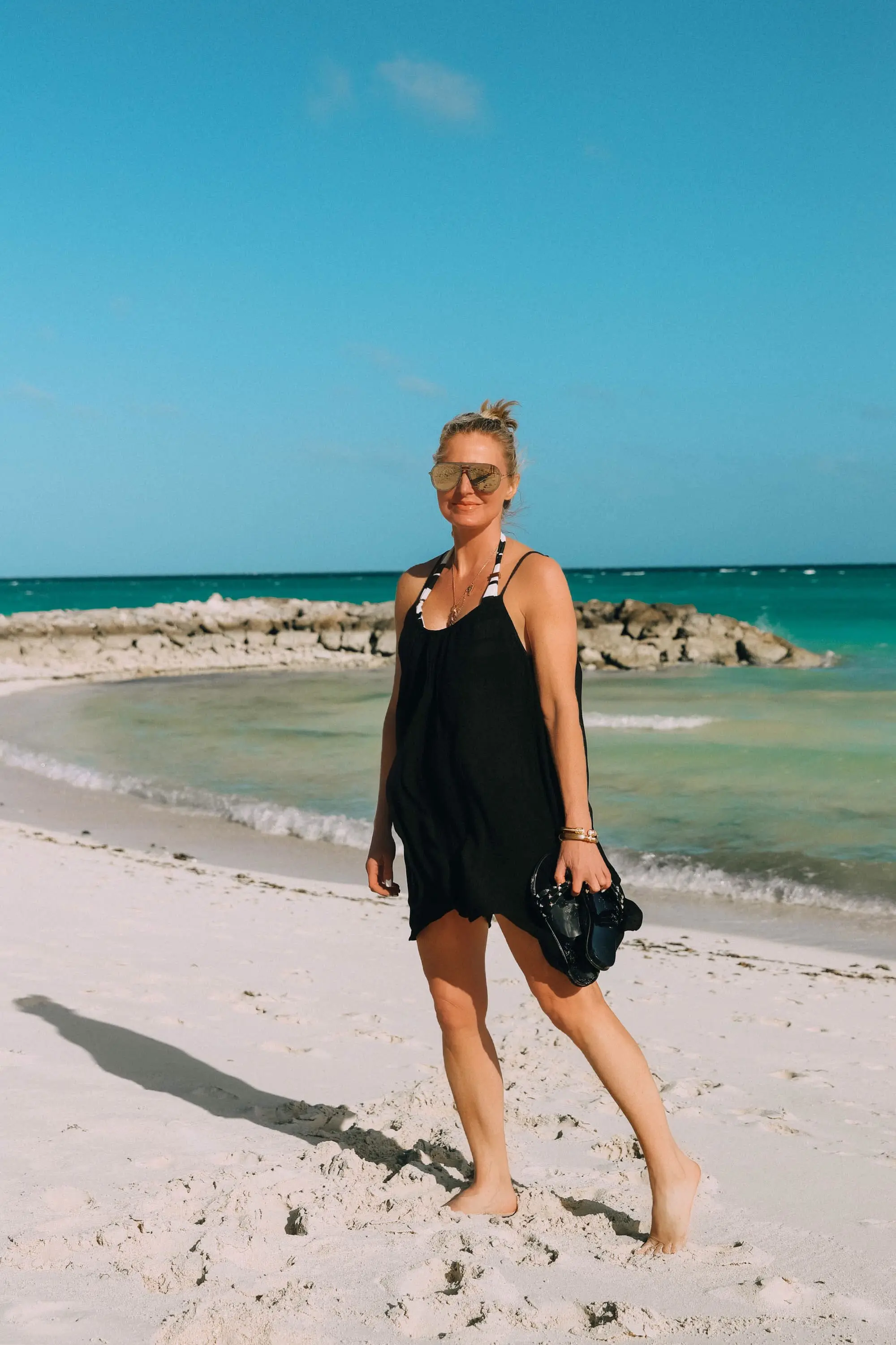 black elan slipdress swimsuit cover up worn over bathing suit on the beach