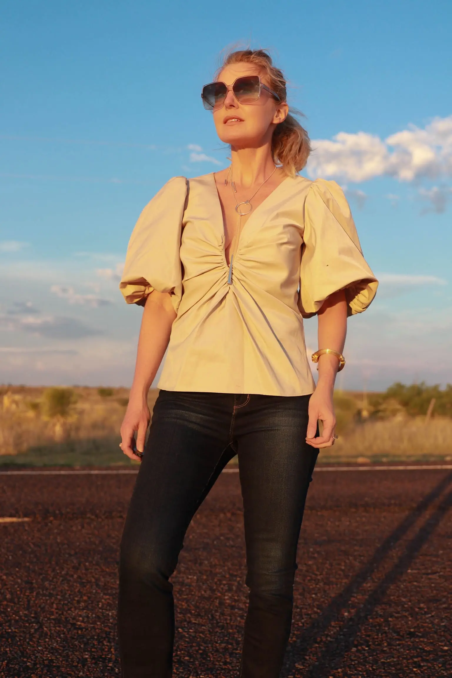 Amanda Uprichard Tops, Fashion blogger Busbee Style wearing a beige puff sleeve top by Amanda Uprichard with dark wash skinny jeans, Valentino sandals, Julie Vos bracelet and ring, and Kendra Scott adjustable necklace in Texas