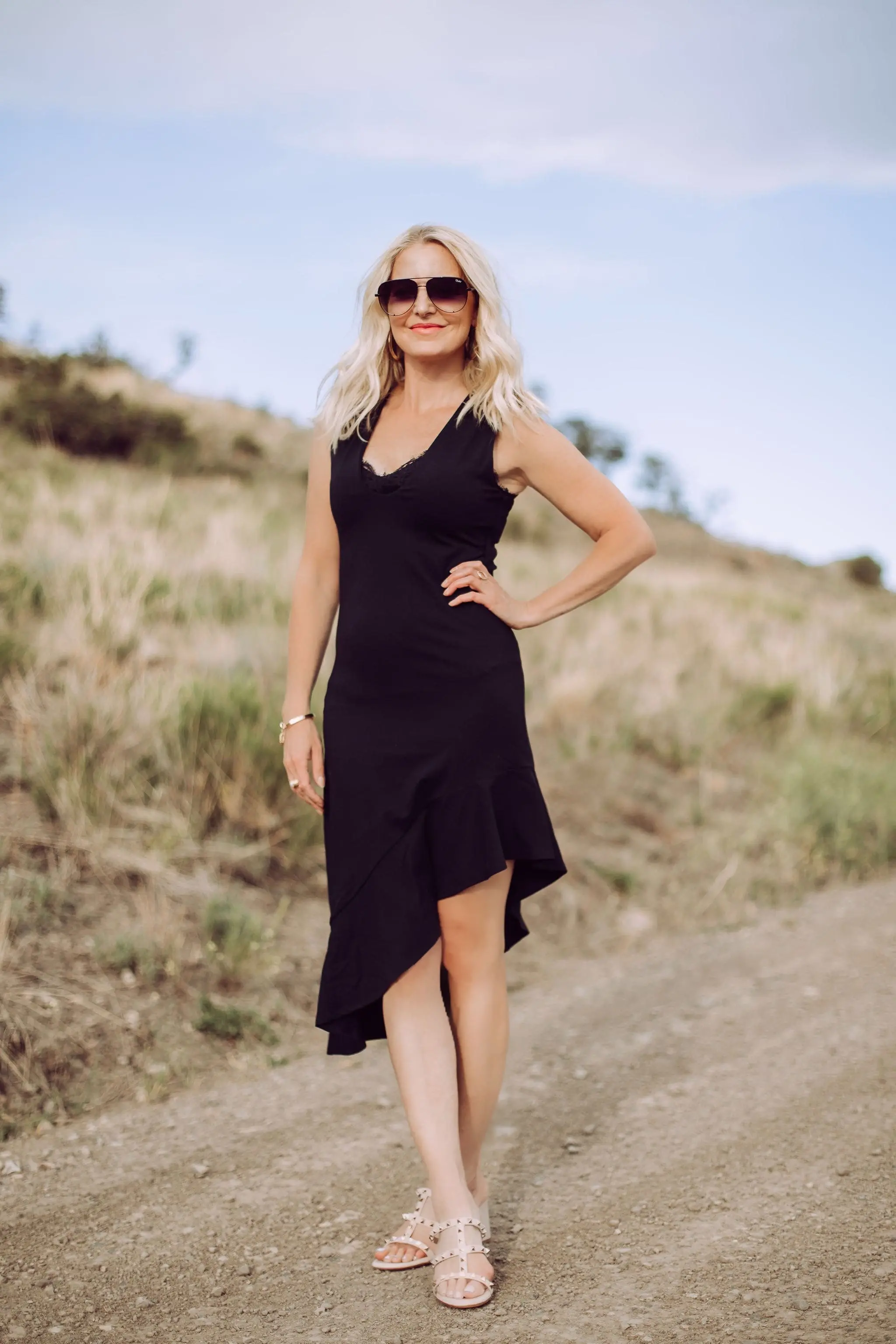 Date Night Outfit Over 40, Fahsion blogger Erin Busbee of Busbee Style wearing a black asymmetrical Susana Monaco dress with lace cami, Valentino Sandals, and QUAY aviator sunglasses in Telluride, Colorado