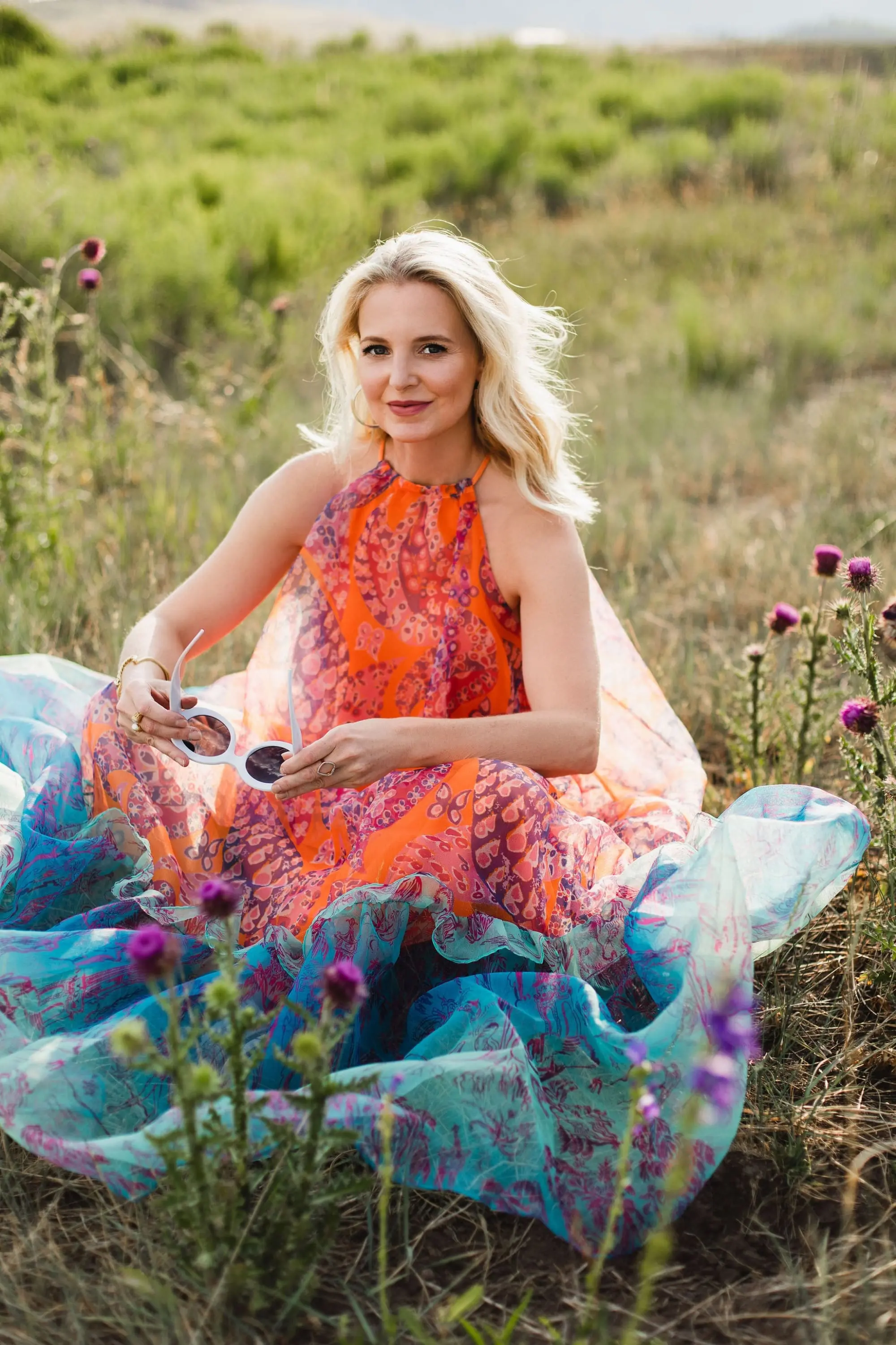 How To Manifest Anything, Fashion blogger Erin Busbee of Busbee Style wearing an orange and blue Staud Ina dress with white sunglasses walking around in Telluride, Colorado, how women can help women, ways women can help other women