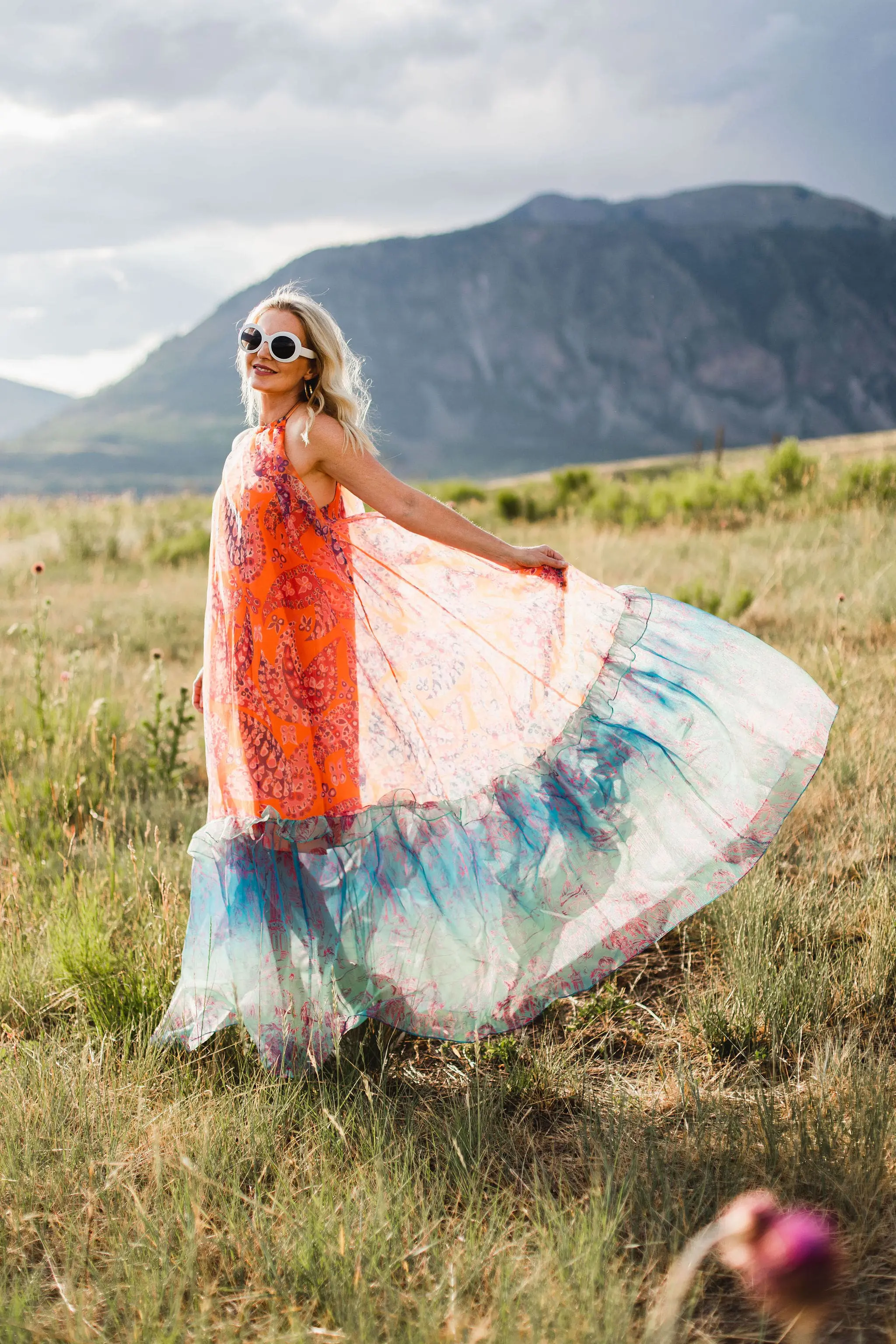 How To Manifest Anything, Fashion blogger Erin Busbee of Busbee Style wearing an orange and blue Staud Ina dress with white sunglasses walking around in Telluride, Colorado